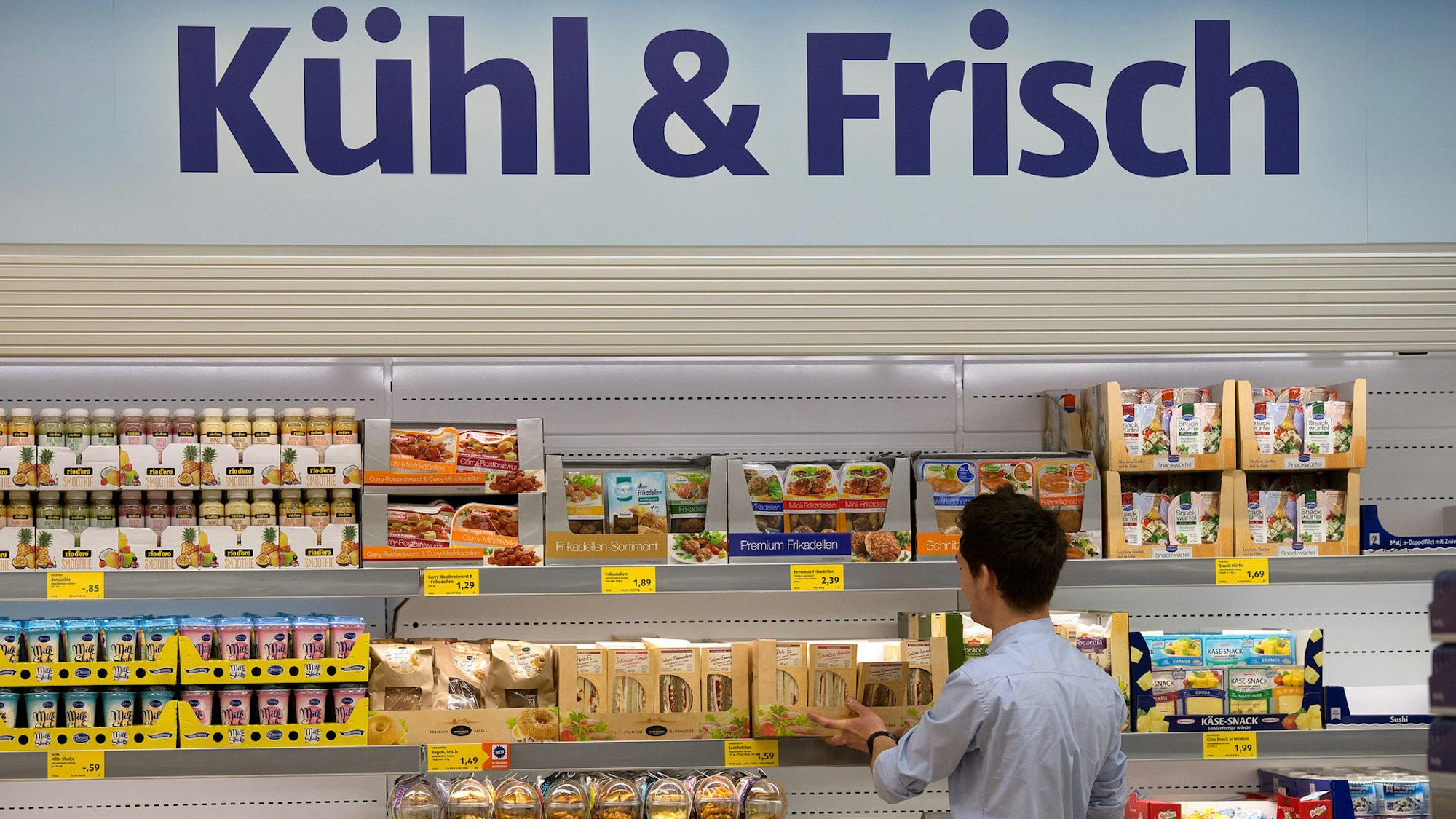 Ein Aldi-Mitarbeiter befüllt 2014 in Düsseldorf (Nordrhein-Westfalen) in der Aldi-Filiale an der Königsallee die Regale. Wegen eines Sorbets, gibt es Zoff. Es darf nicht die geschützte Bezeichnung Champagner tragen.