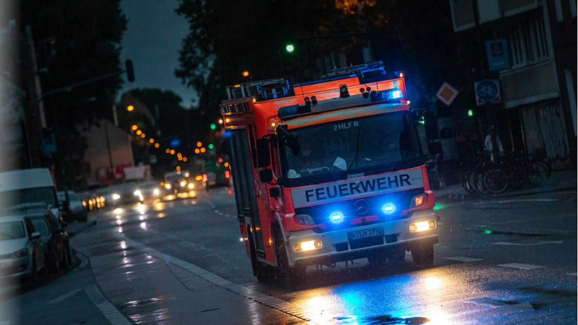 Feuerwehr-Auto fährt nachts durch Köln.