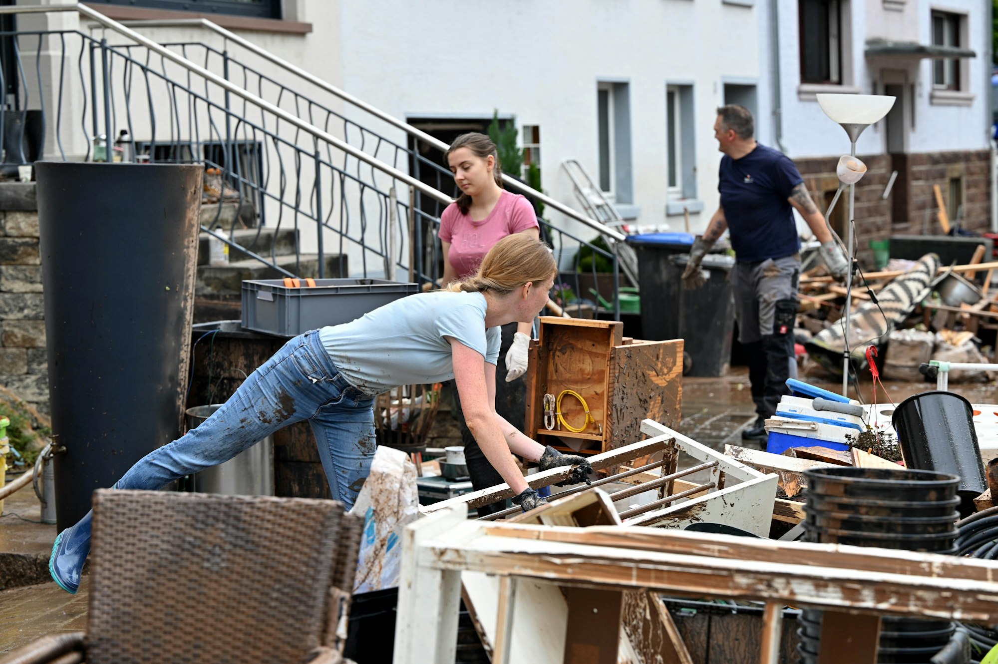 Die Menschen räumen nach dem Hochwasser zerstörte Möbel auf die Straße.