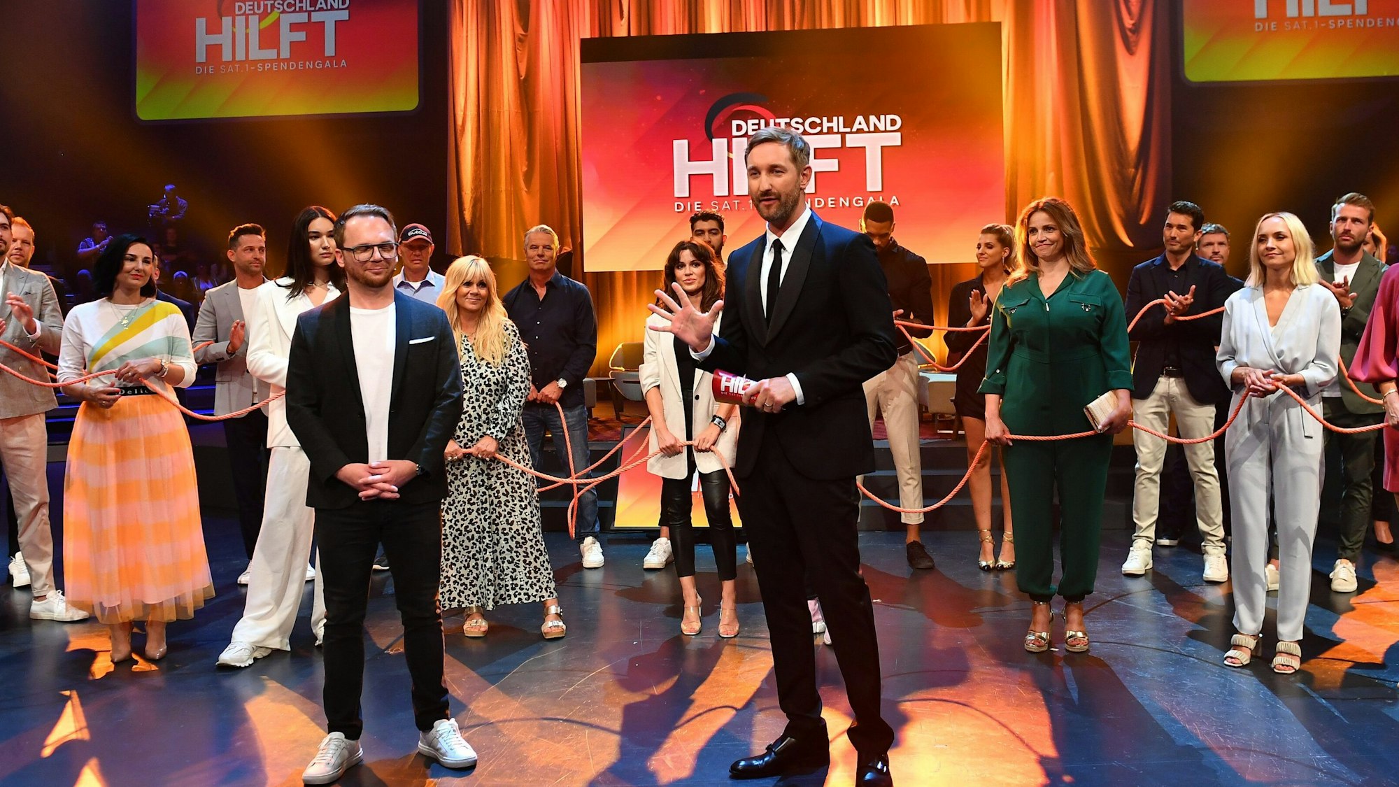 Moderator Daniel Boschmann und Ralf Schmitz stehen mit ihren Gästen in der Sendung „Deutschland hilft. Die Sat.1-Spendengala“ am 24. Juli 2021. Es kamen mehr als 31 Millionen Euro für Flutopfer zusammen.