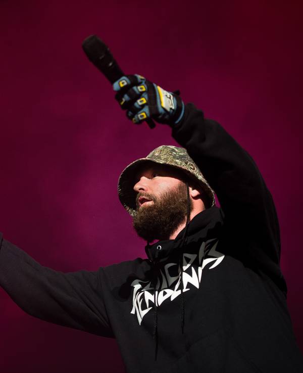 Fred Durst trägt auf der Bühne einen Anglerhut, einen dichten Bart, einen langärmeligen Kaputzen-Pulli und Handschuhe.
