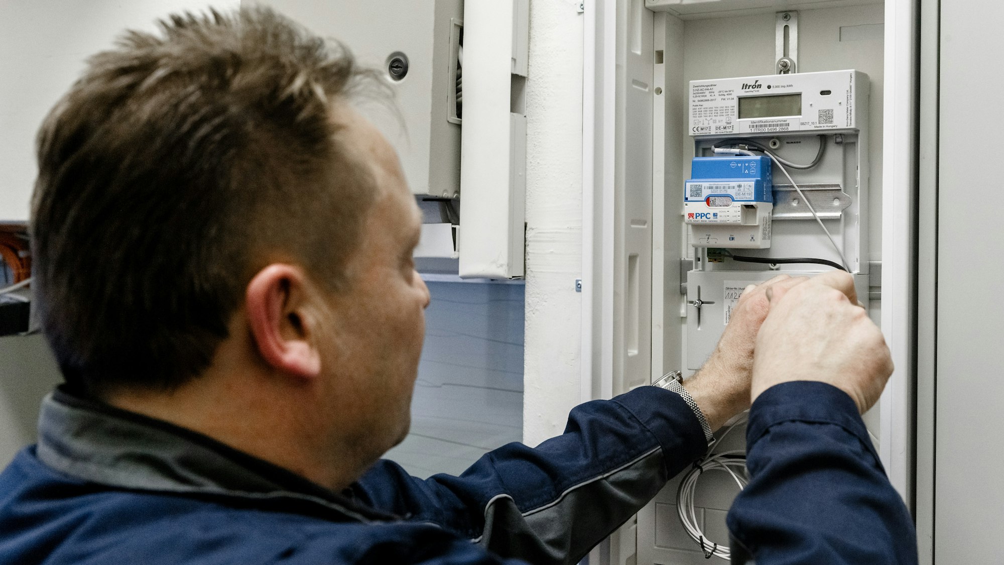 Ein Elektriker montiert einen digitalen Stromzähler.