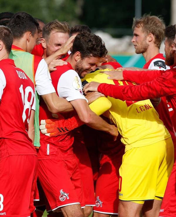 Die Spieler des 1. FC Köln umarmen Marvin Schwäbe.