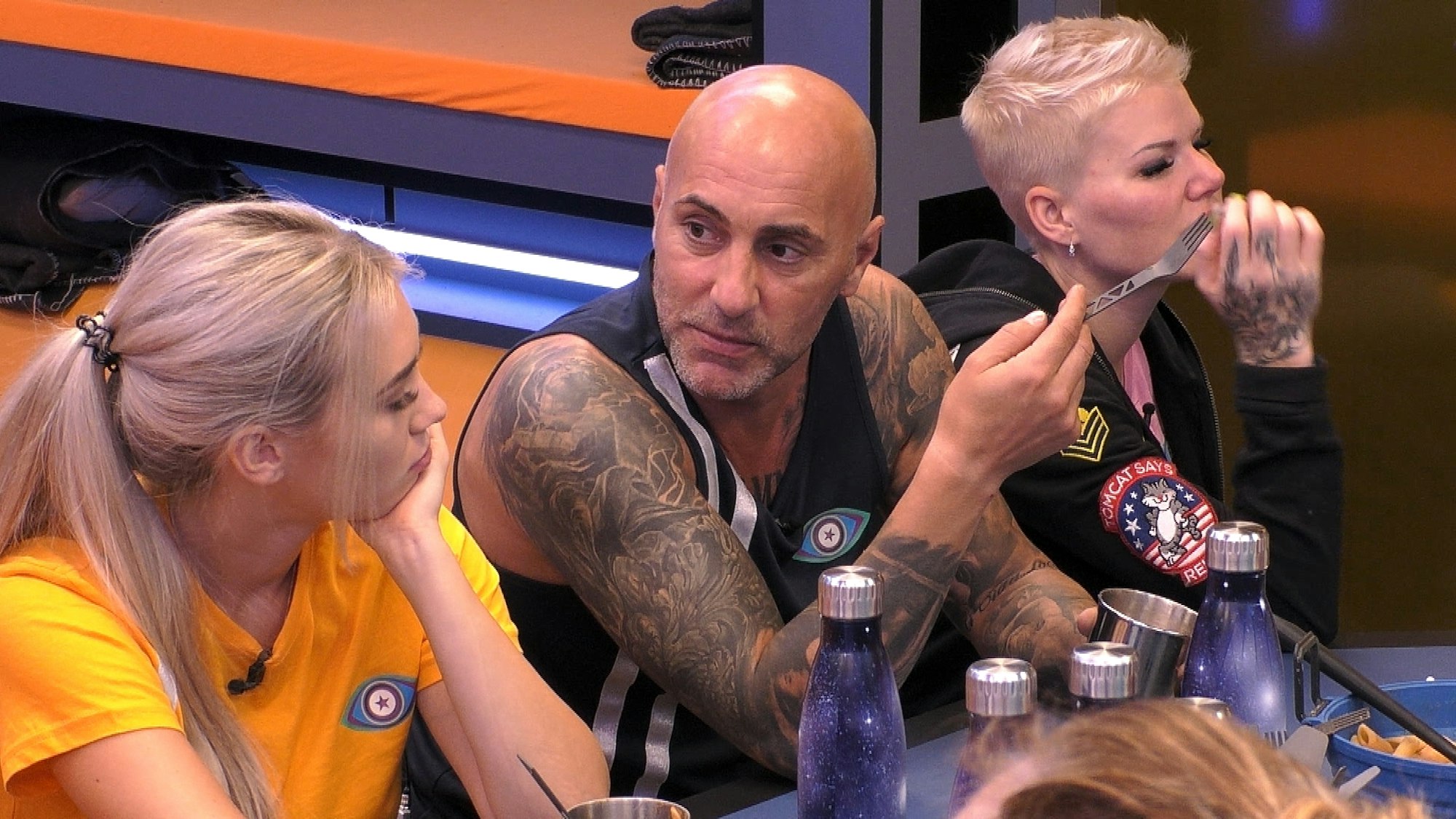 Paco Steinbeck sitzt mit Ina Aogo und Melanie Müller zusammen am Tisch bei Promi Big Brother