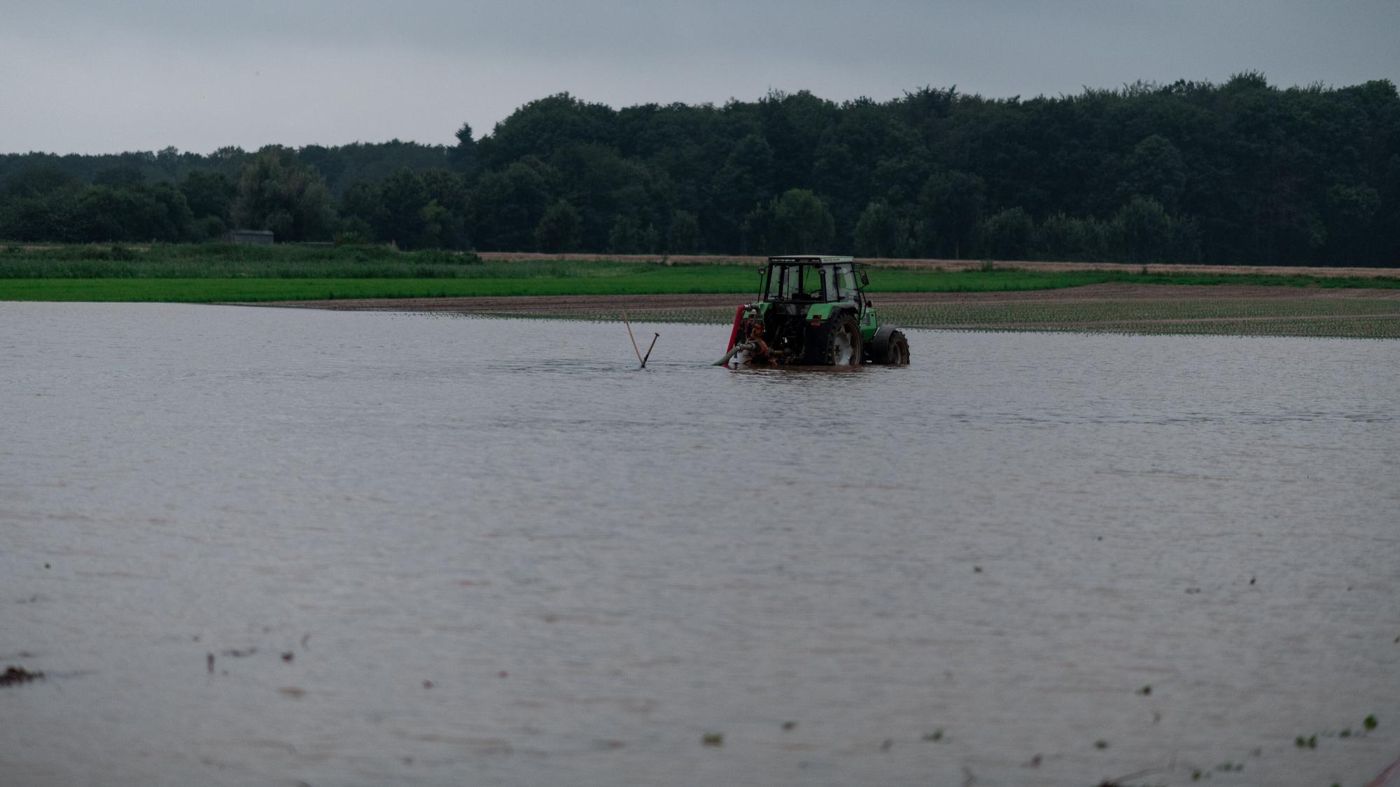 Ein Traktor steht auf einem gefluteten Feld bei Heimerzheim.
