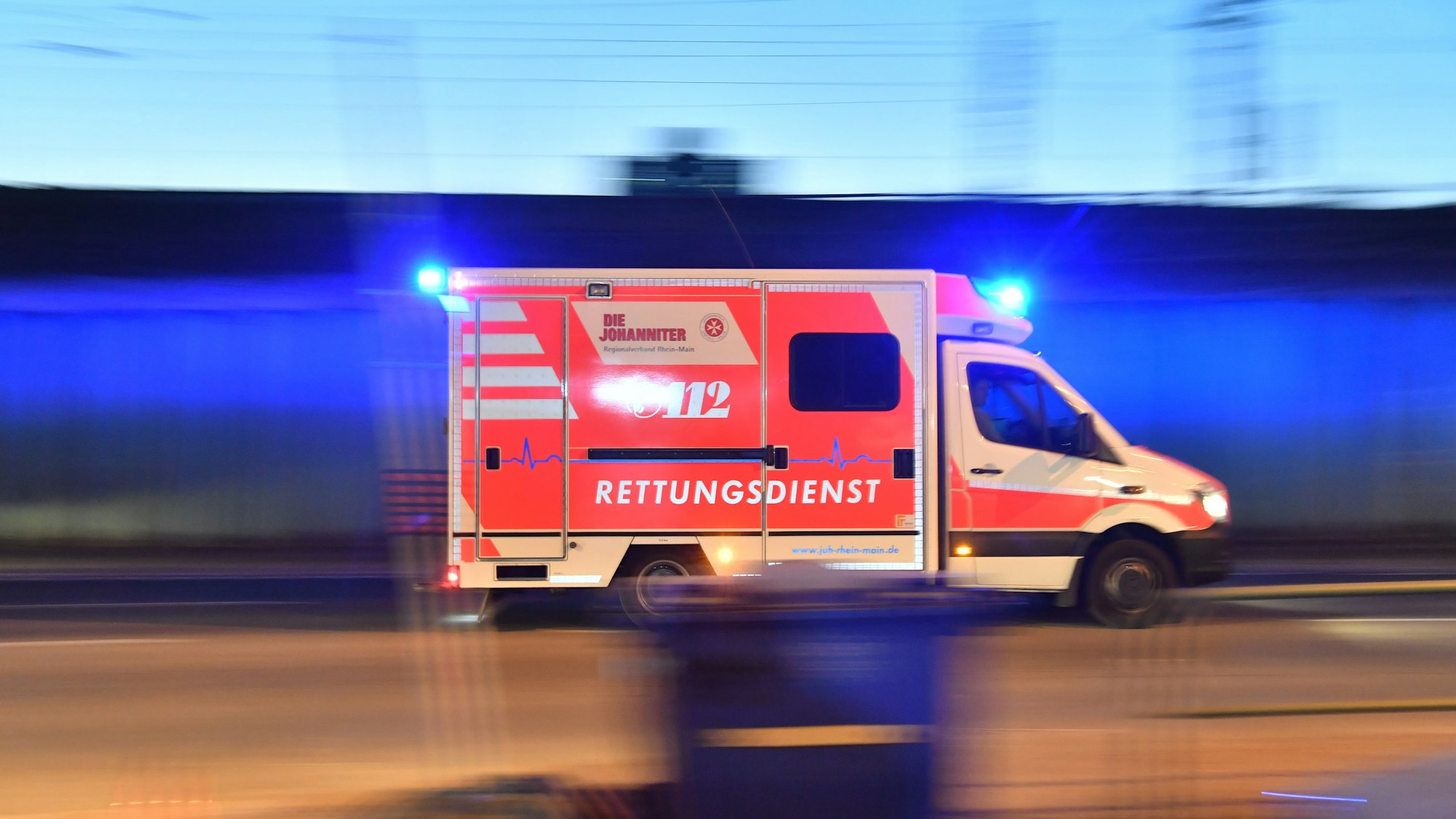 Ein Rettungswagen ist mit eingeschaltetem Blaulicht im Einsatz.