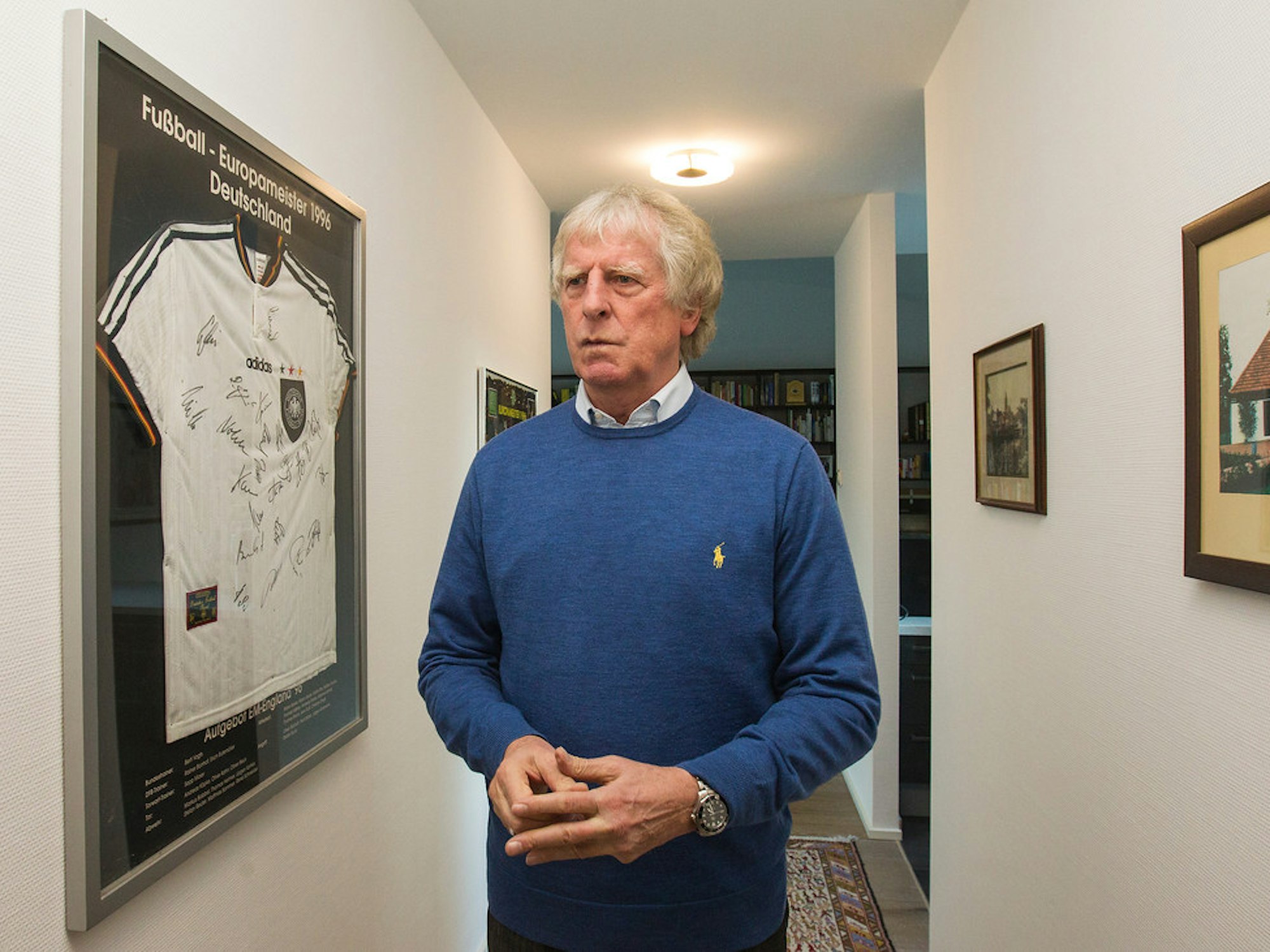 Erich Rutemöller vor einem eingerahmten Trikot.