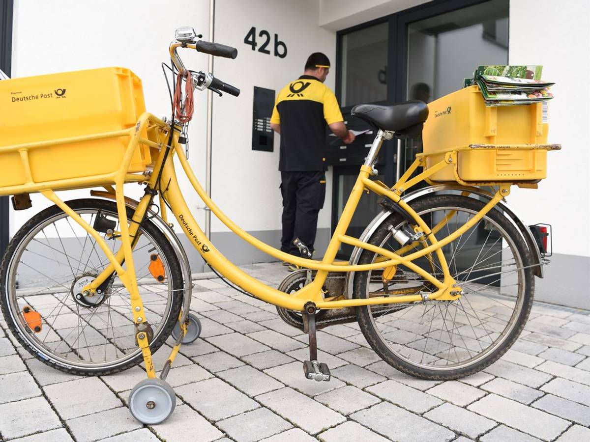 Postbote vor der Tür eines Hauses in Frankfurt am Main.