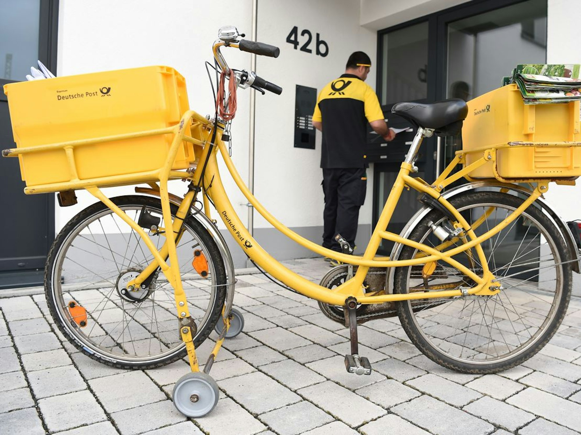 Postbote vor der Tür eines Hauses in Frankfurt am Main.