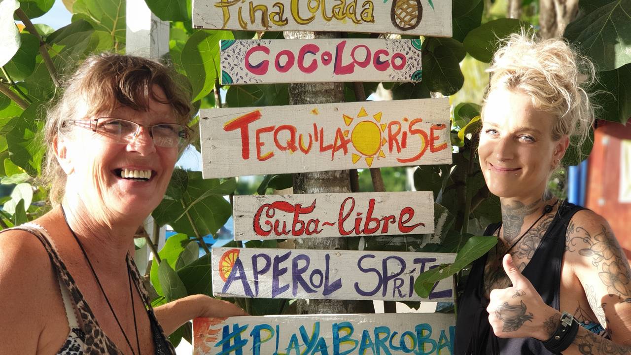 Goodbye Deutschland: Sonja Schröter steht mit ihrer Tochter Nena neben einer Palme, an welcher eine Cocktailkarte genagelt ist.