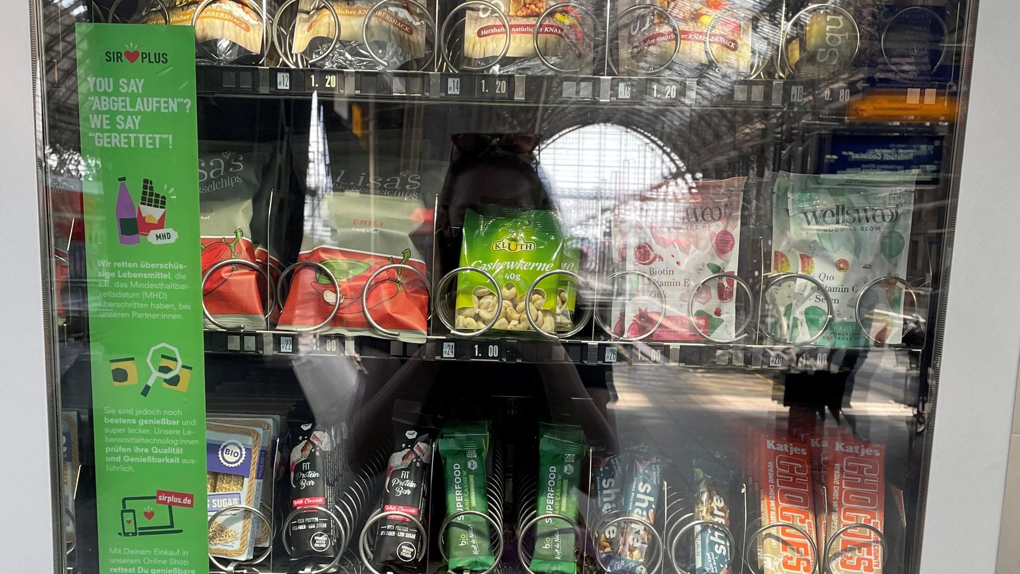 Vegan, Bio, fast abgelaufen: Im „Rettomat“ gibt es zahlreiche Snacks für Reisende. Der Automat informiert außerdem über das Problem der Lebensmittelverschwendung.