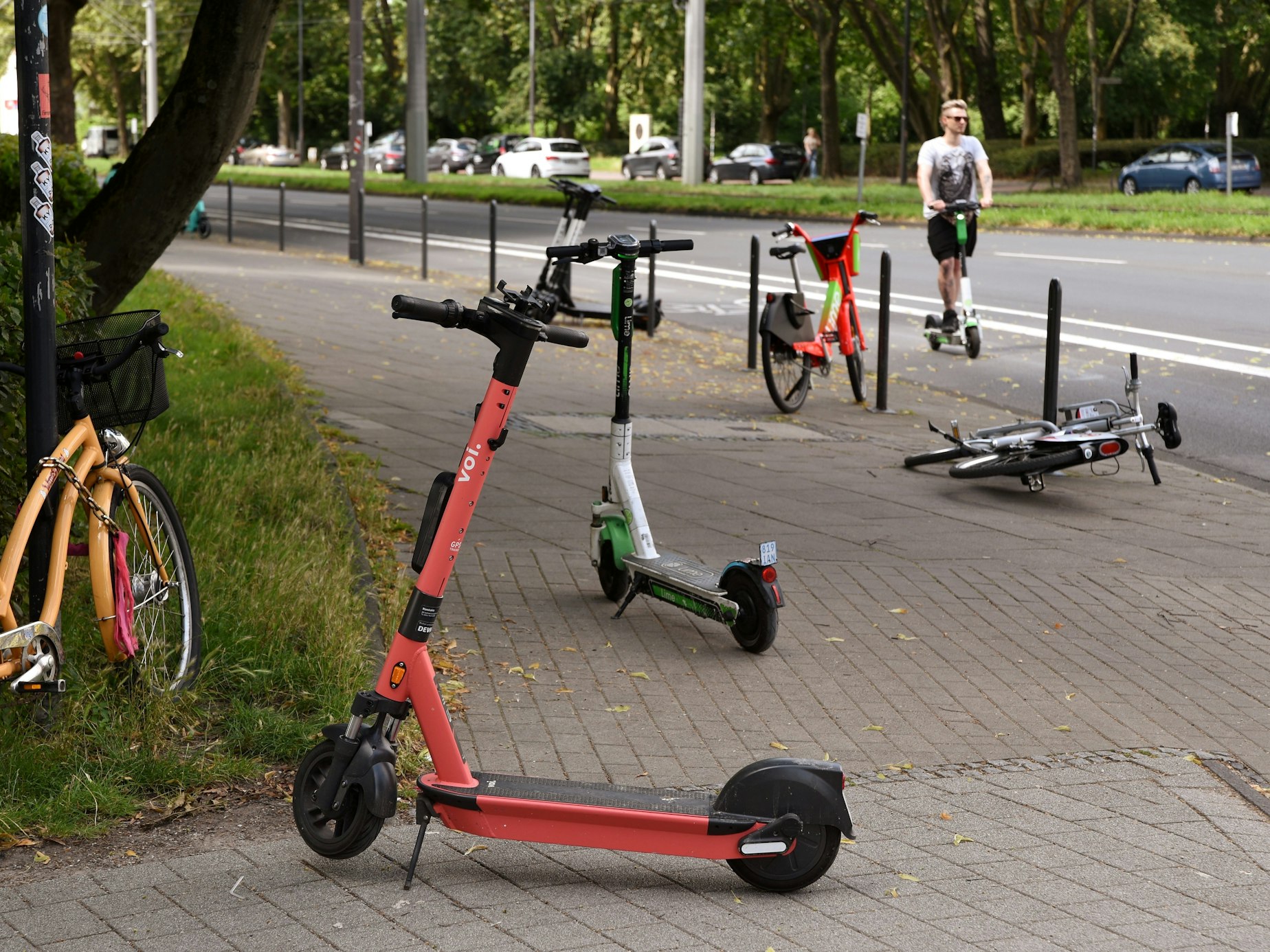 E-Scooter stehen auf dem Gehweg an der Aachener Straße in Köln.
