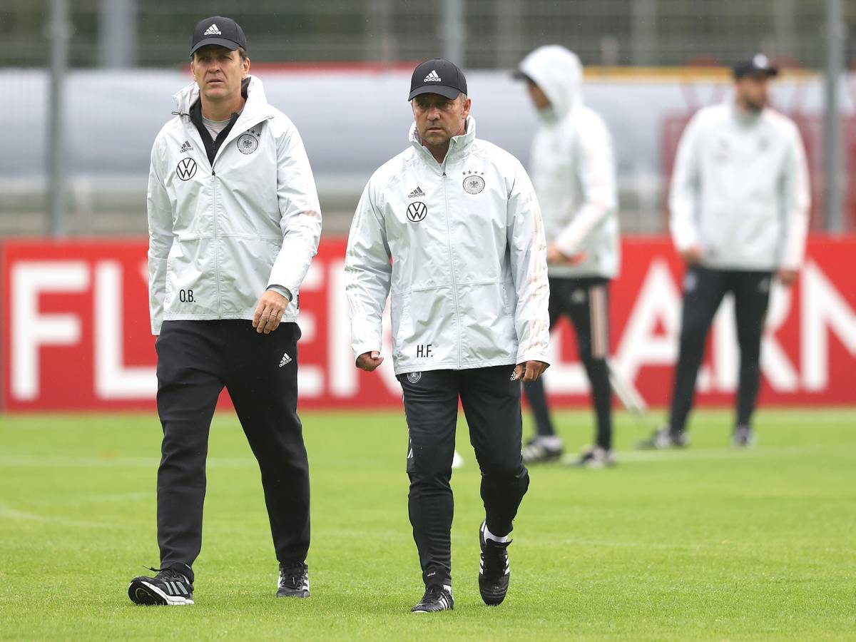 Oliver Bierhoff und Hansi Flick gehen gemeinsam über den Platz beim Training.