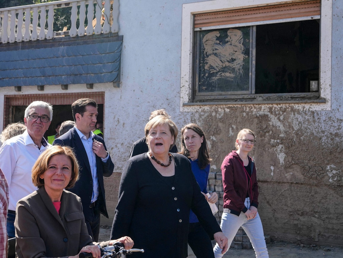 German Chancellor Angela Merkel, center, and Malu Dreyer, left, Prime Minister of Rhineland-Palatinate, talk to residents during their visit to the flood-damaged district Altenburg, part of the municipality of Altenahr, Germany, on September 3, 2021. - After days of extreme downpours, devastating floods hit the valley of the river Ahr in July 2021. (Photo by Markus Schreiber / POOL / AFP)