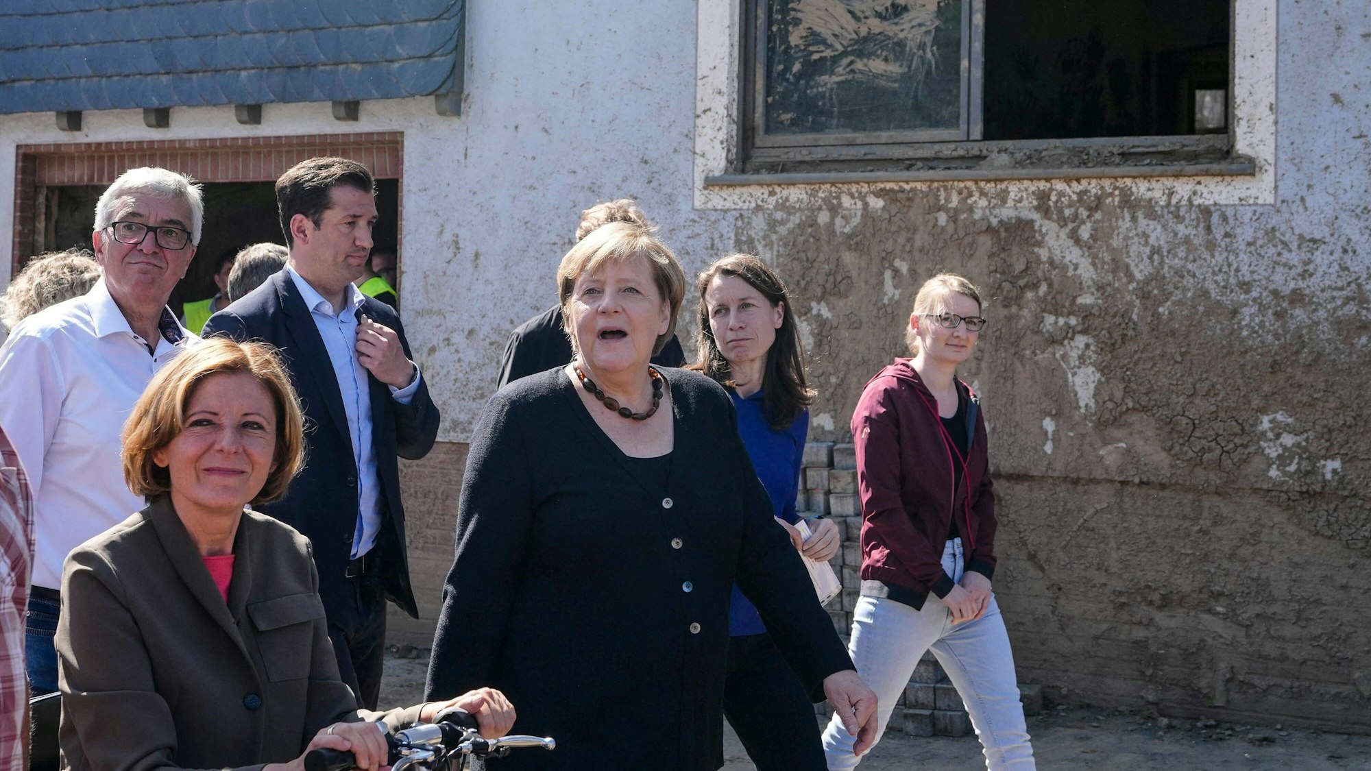 German Chancellor Angela Merkel, center, and Malu Dreyer, left, Prime Minister of Rhineland-Palatinate, talk to residents during their visit to the flood-damaged district Altenburg, part of the municipality of Altenahr, Germany, on September 3, 2021. - After days of extreme downpours, devastating floods hit the valley of the river Ahr in July 2021. (Photo by Markus Schreiber / POOL / AFP)