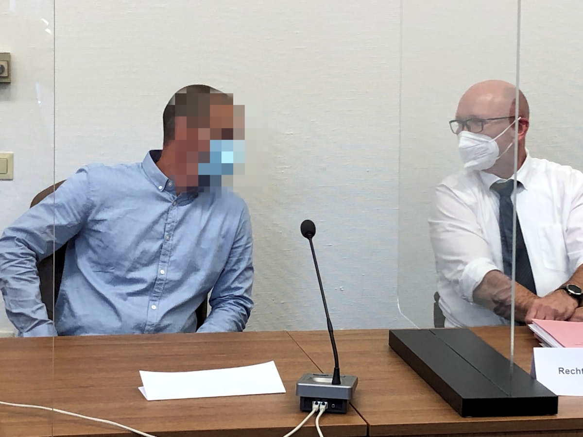 Der Angeklagte und sein Anwalt reden miteinander.