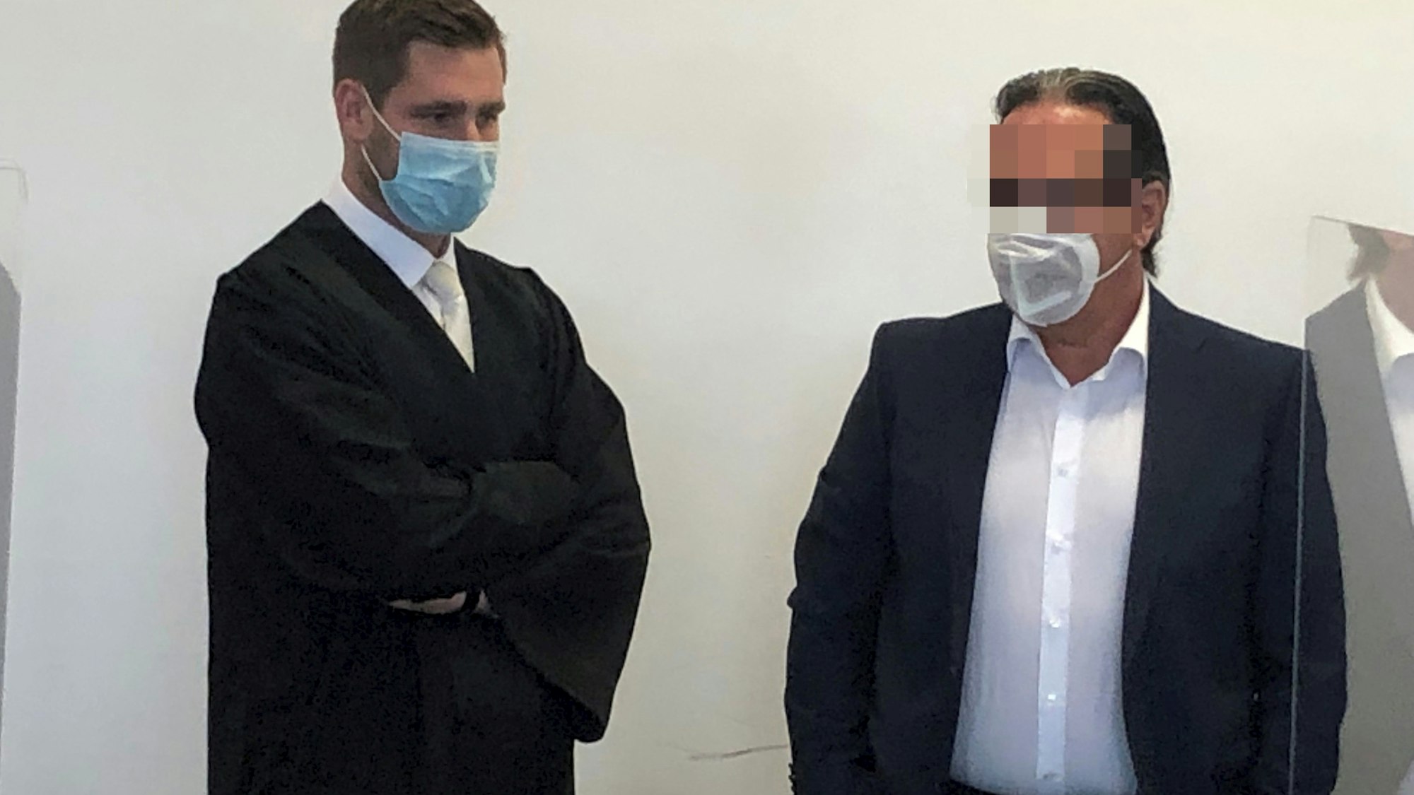 Ein Angeklagter steht neben seinem Anwalt.