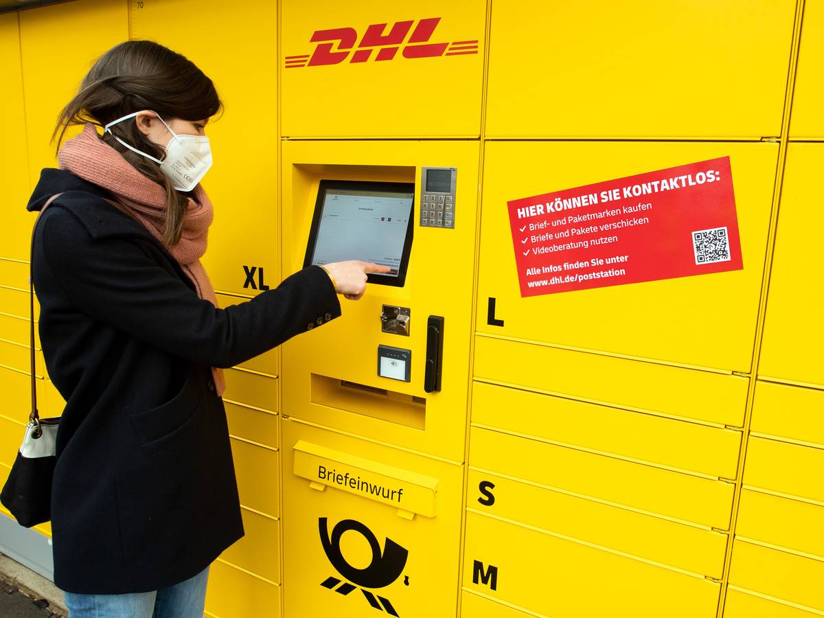 Eine Post-Mitarbeiterin bedient eine neue Poststation.