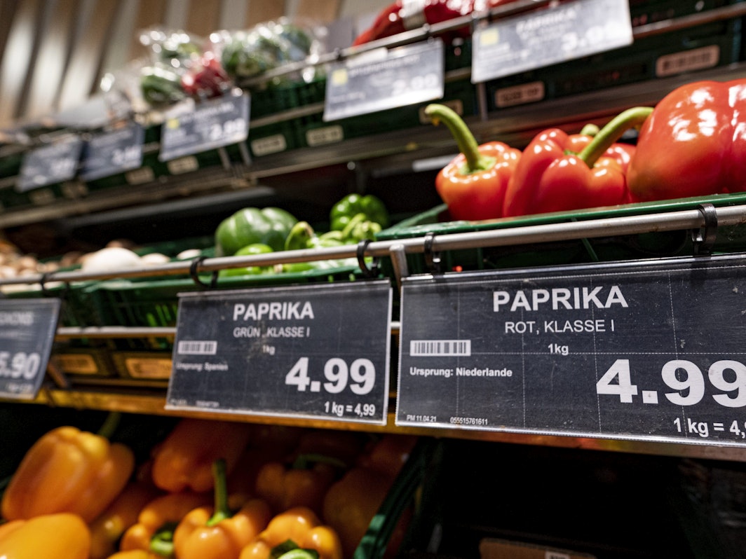 Obst und Gemüse im Supermarkt probieren ist nicht erlaubt. Preisschilder von Paprikas hängen an der Gemüsetheke in einem Supermarkt.