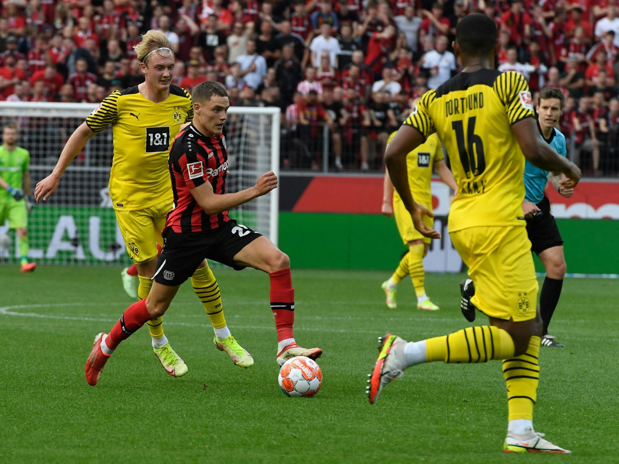 Dortmunds Julian Brandt verfolgt Leverkusens Florian Wirtz.