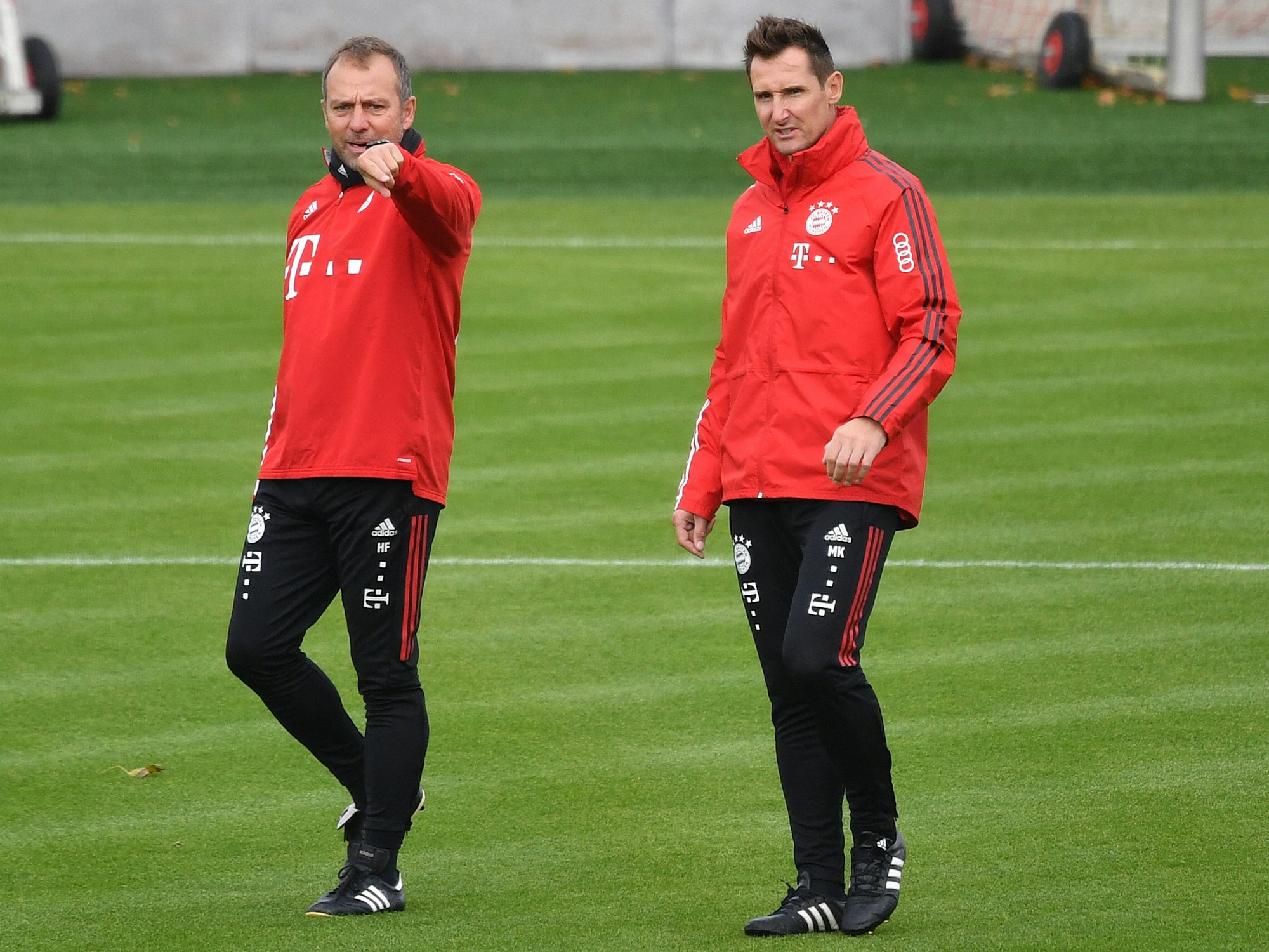 Klose und Hans Flick stehen auf dem Trainingsgelände des FC Bayern, Flick zeigt Klose mit dem Finger, was zu tun ist.