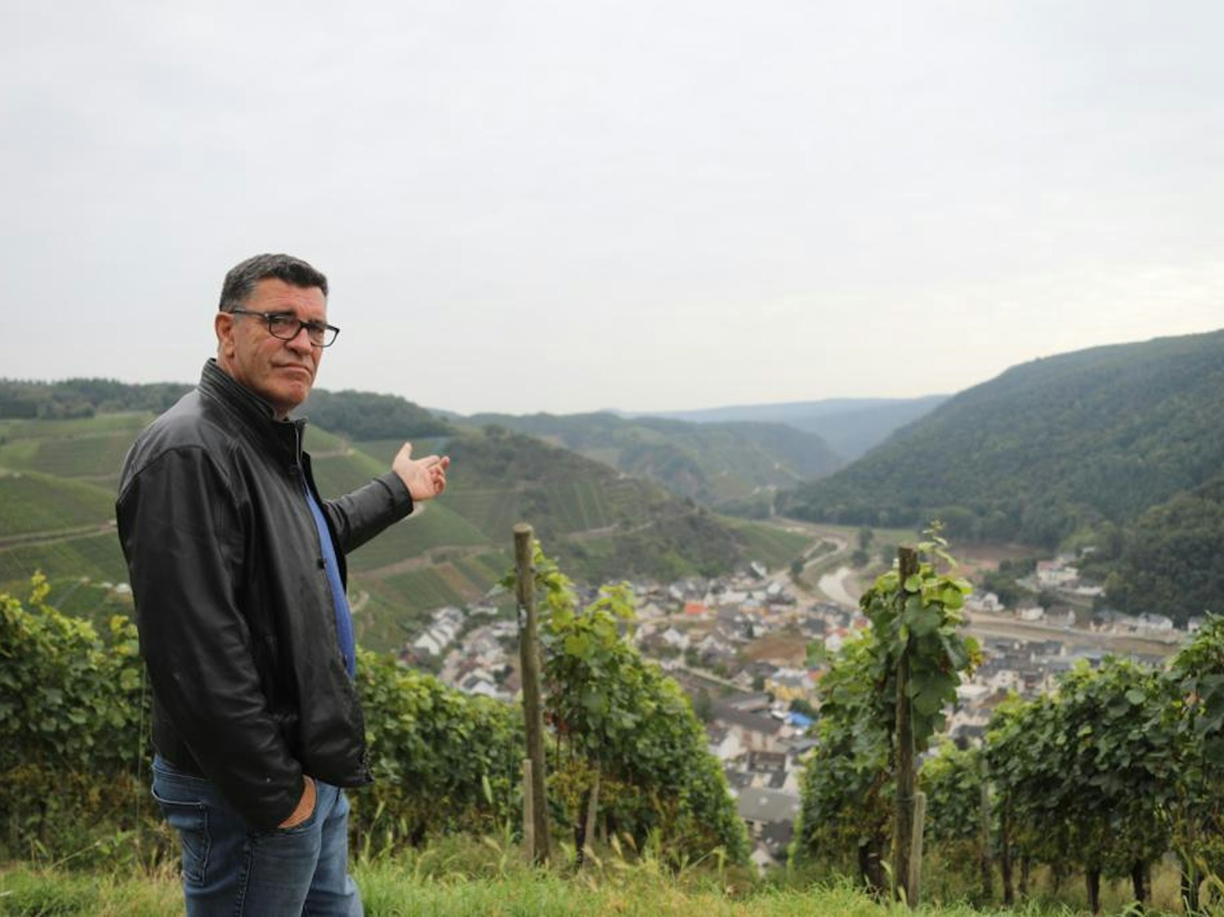 Anwohner Volker Gütten zeigt auf das durch die Hochwasserkatastrophe ruinierte Dernau im Ahrtal.