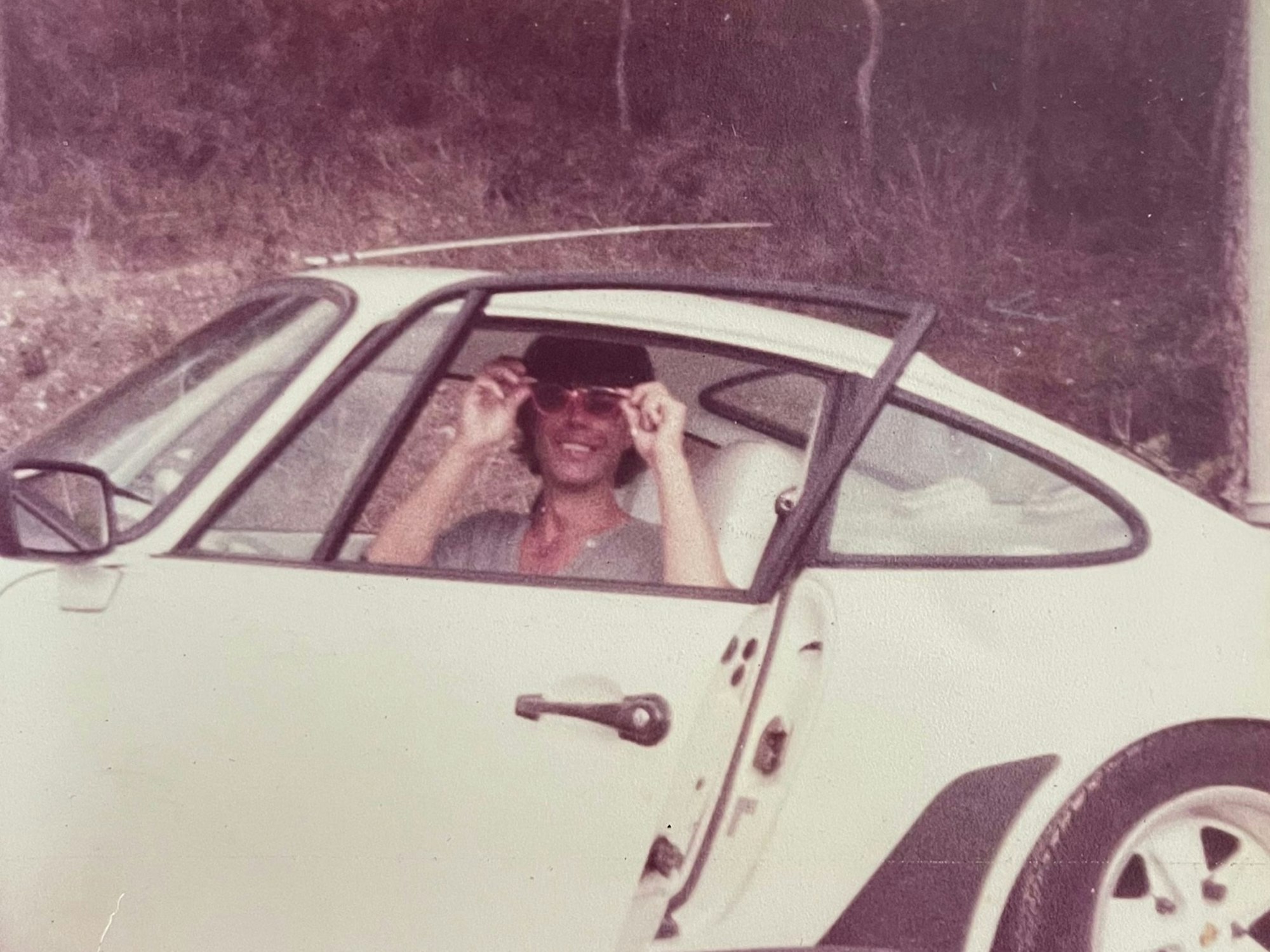 Wolfgang Heider sitzt in einem Porsche.