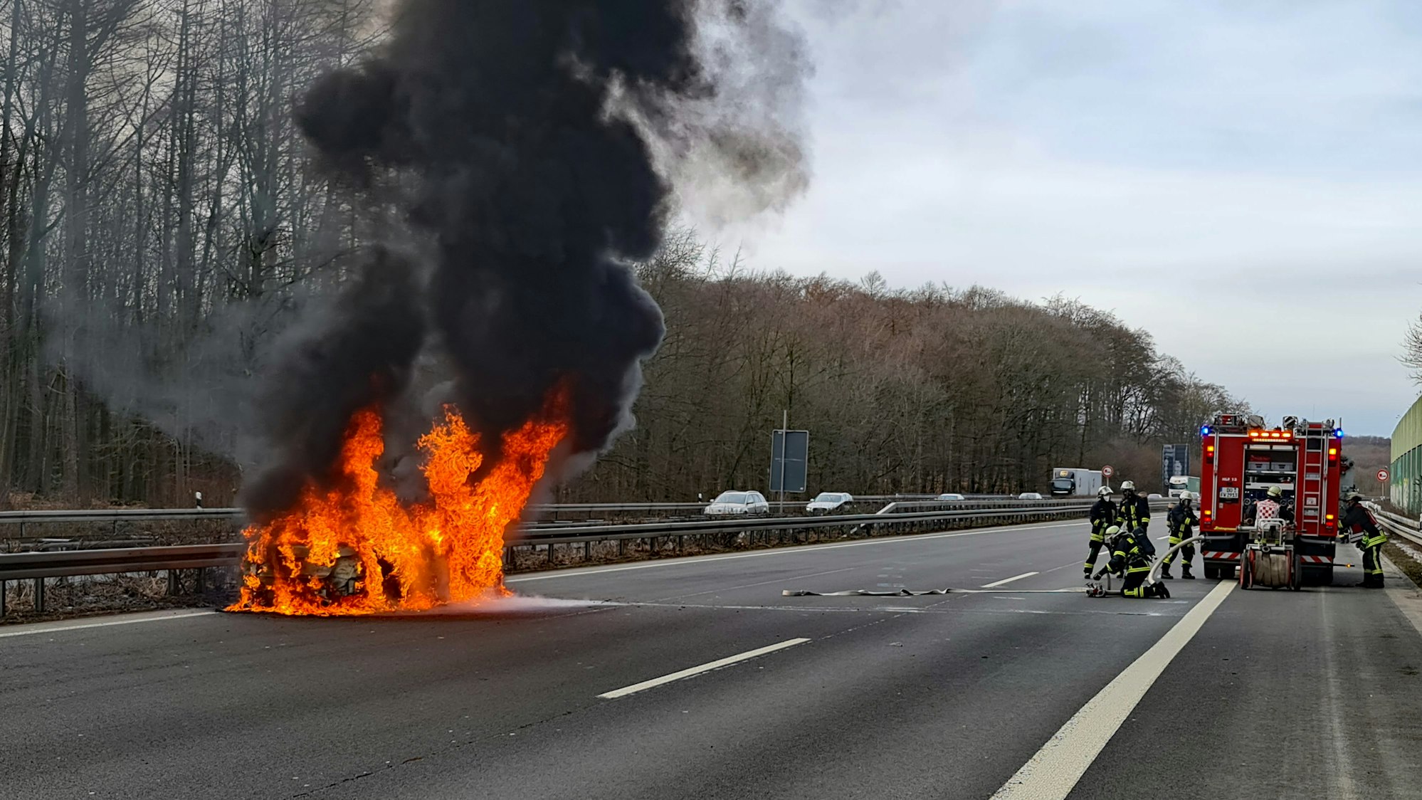 Einsatzkräfte der Feuerwehr löschen am 18. Februar 2021 ein Auto, das auf der Autobahn 45 komplett in Flammen steht. Die zwei Fahrerinnen konnten den Wagen rechtzeitig verlassen.