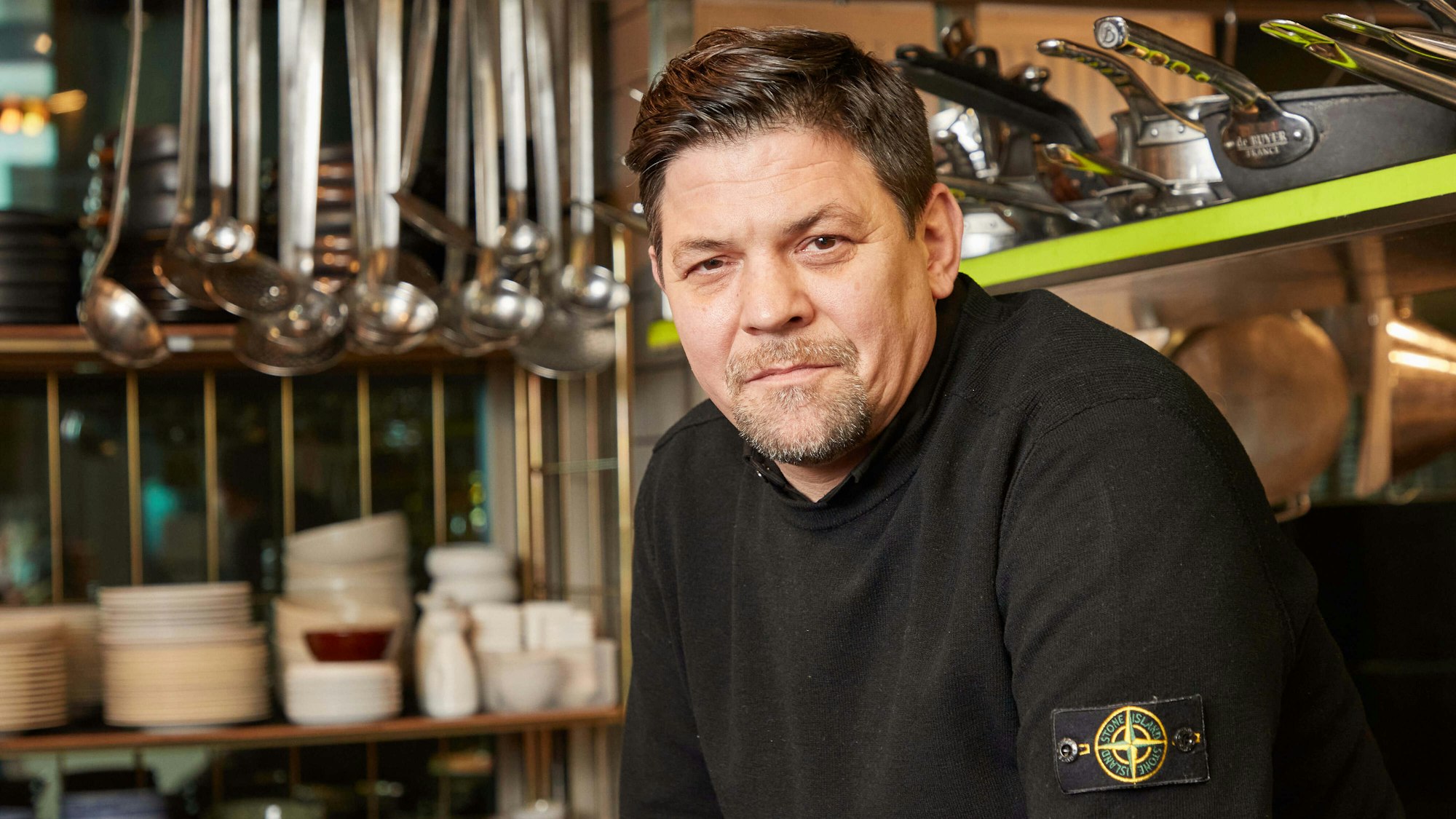 Fernsehkoch Tim Mälzer sitzt in der Küche seines Restaurants „"Die Gute Botschaft“".