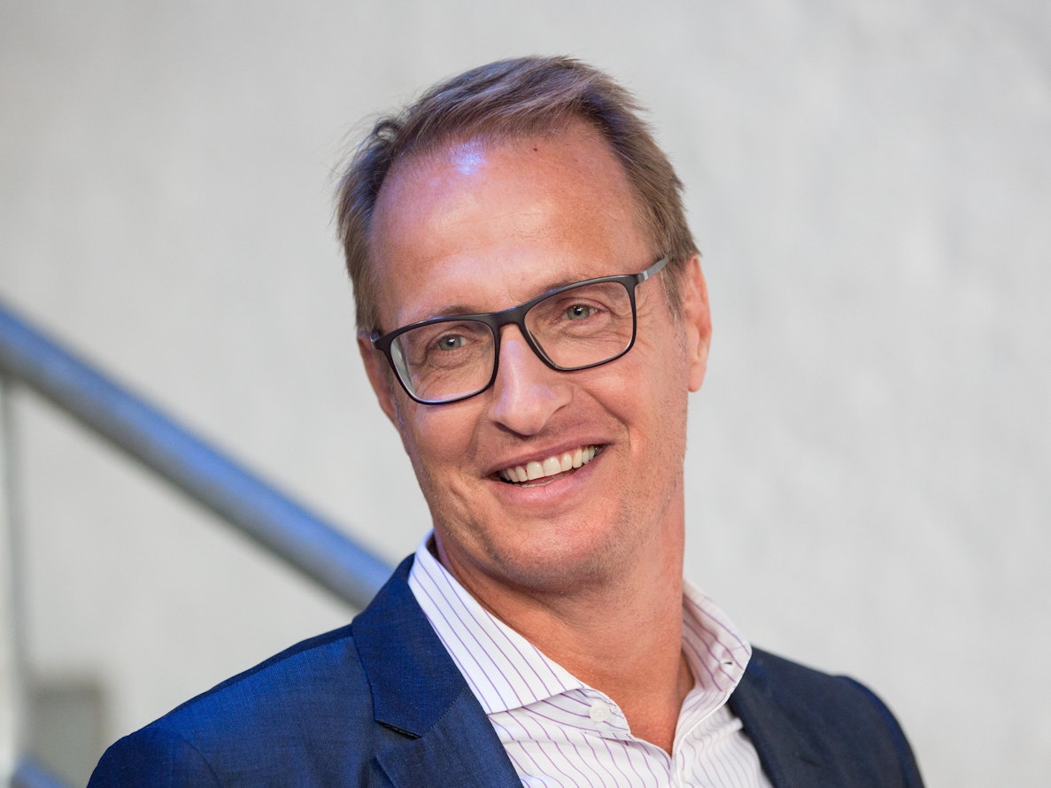 Moderator Florian König lächelt in die Kamera.
