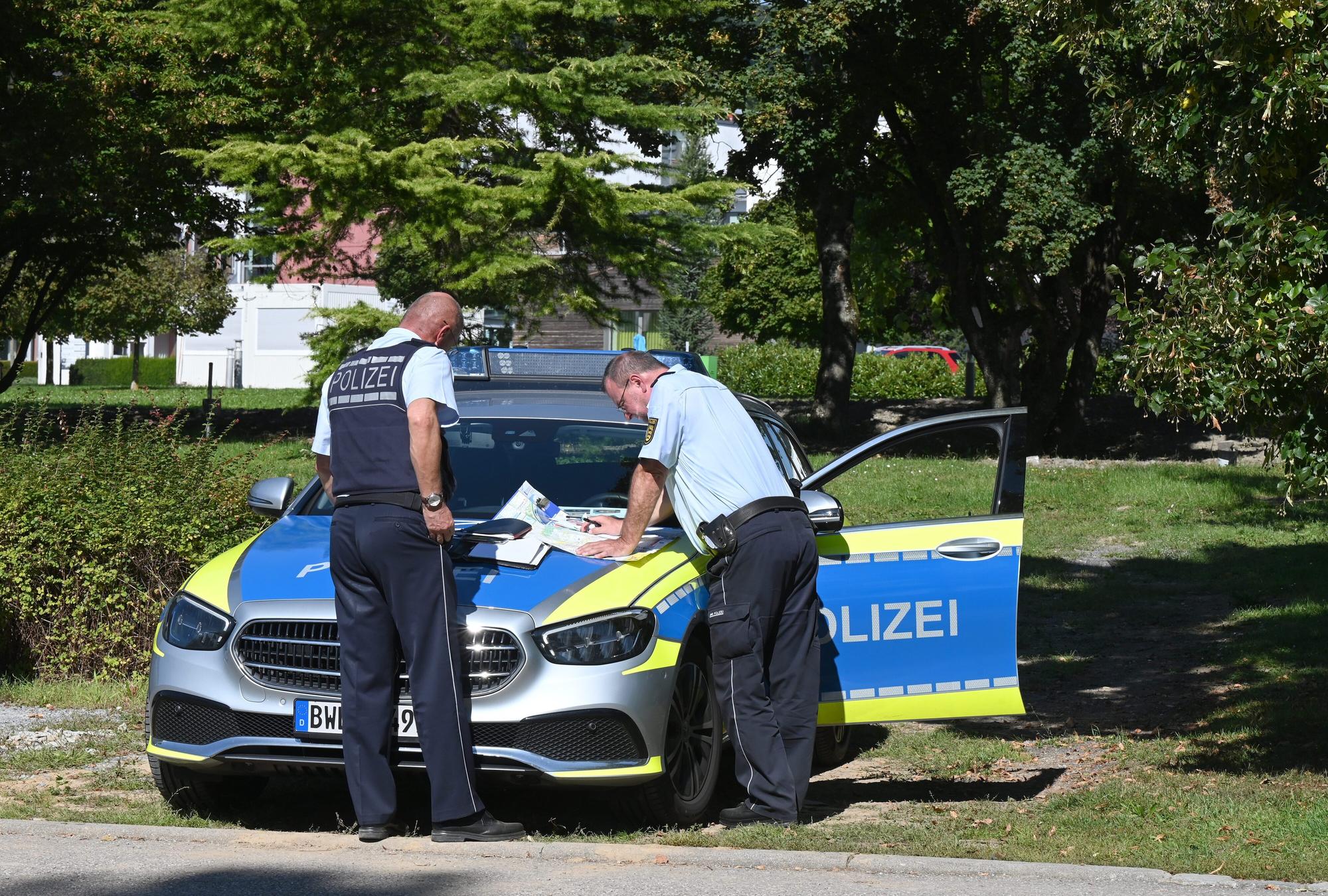 Polizisten besprechen sich vor der Klinik am Weissenhof in Weinsberg. Strafgefangene waren zuvor aus der Psychatrie ausgebrochen.