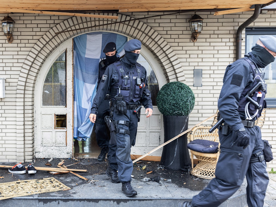 Polizisten verlassen die Leverkusener Villa nach der Razzia.