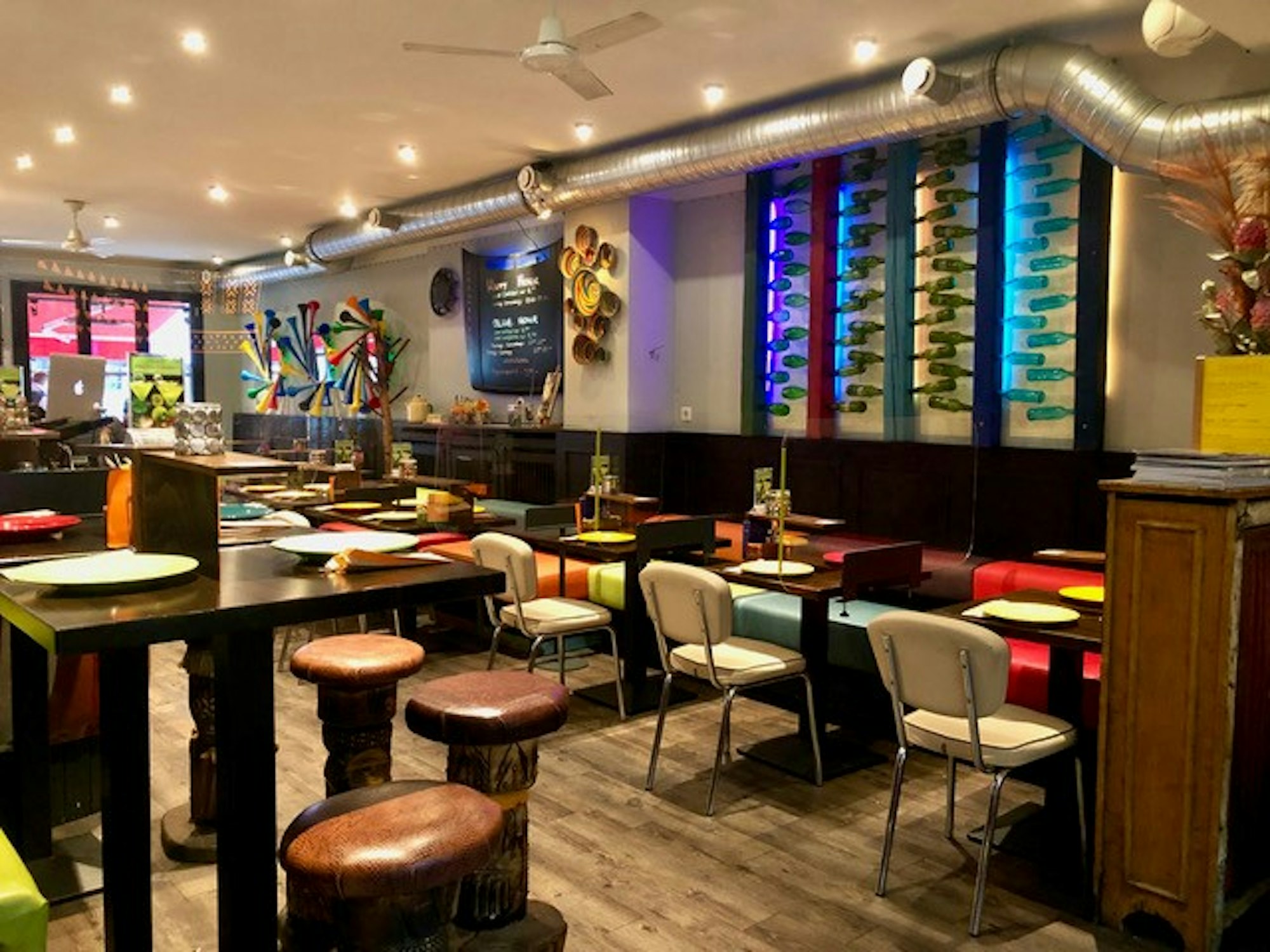 Der Innenbereich des Restaurants besteht aus bunten Tischen und Stühlen.