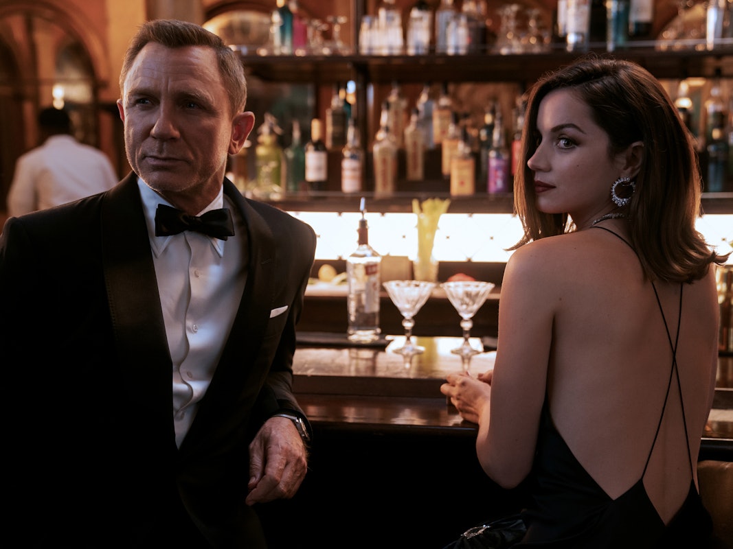 Daniel Craig als James Bond und Ana de Armas als Agentin Paloma stehen in einer Szene des Films „James Bond 007 - Keine Zeit zu sterben“ an einer Bar.