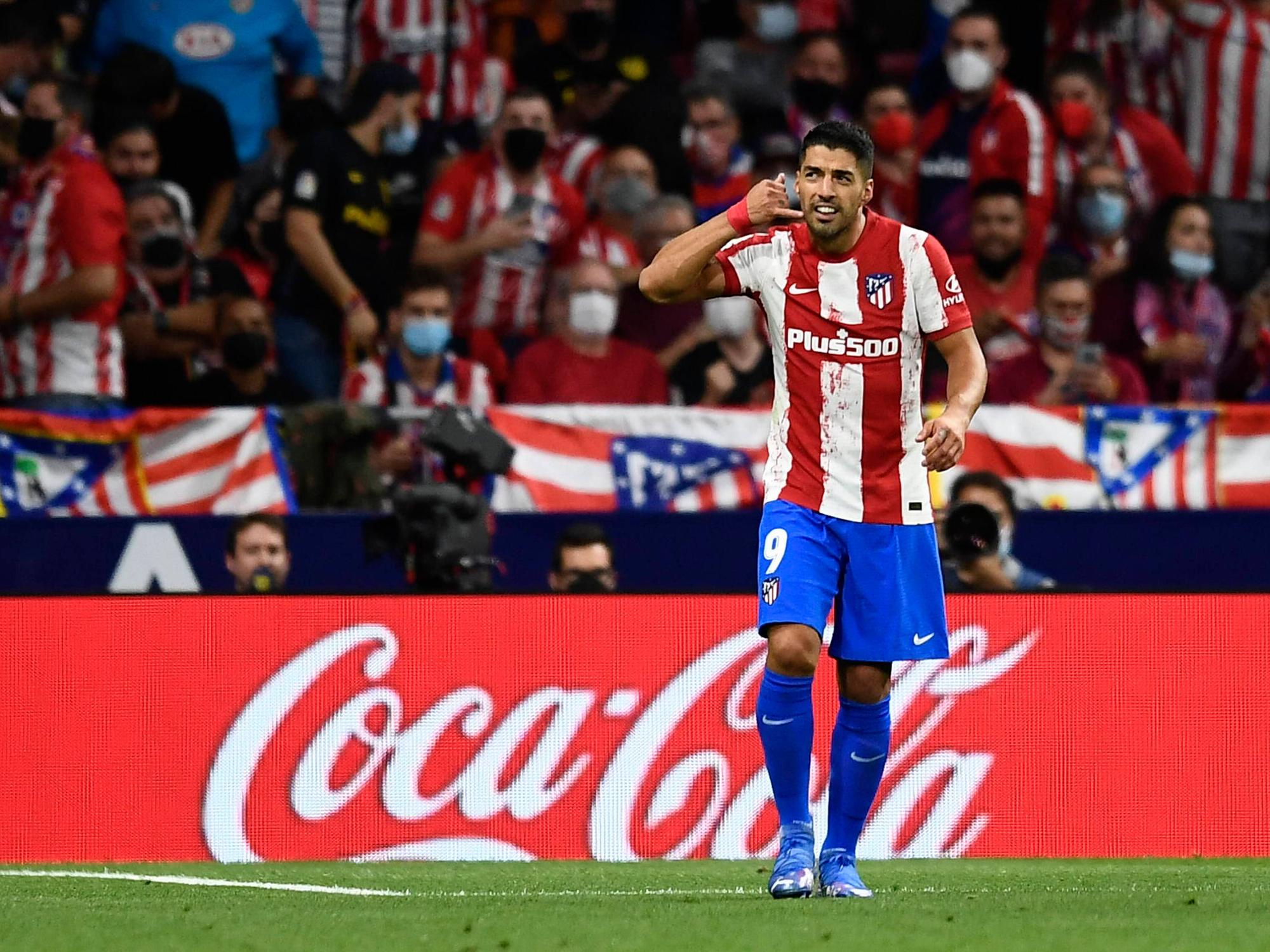 Luis Suárez blickt, während er eine Telefon-Geste macht, auf die Tribüne.