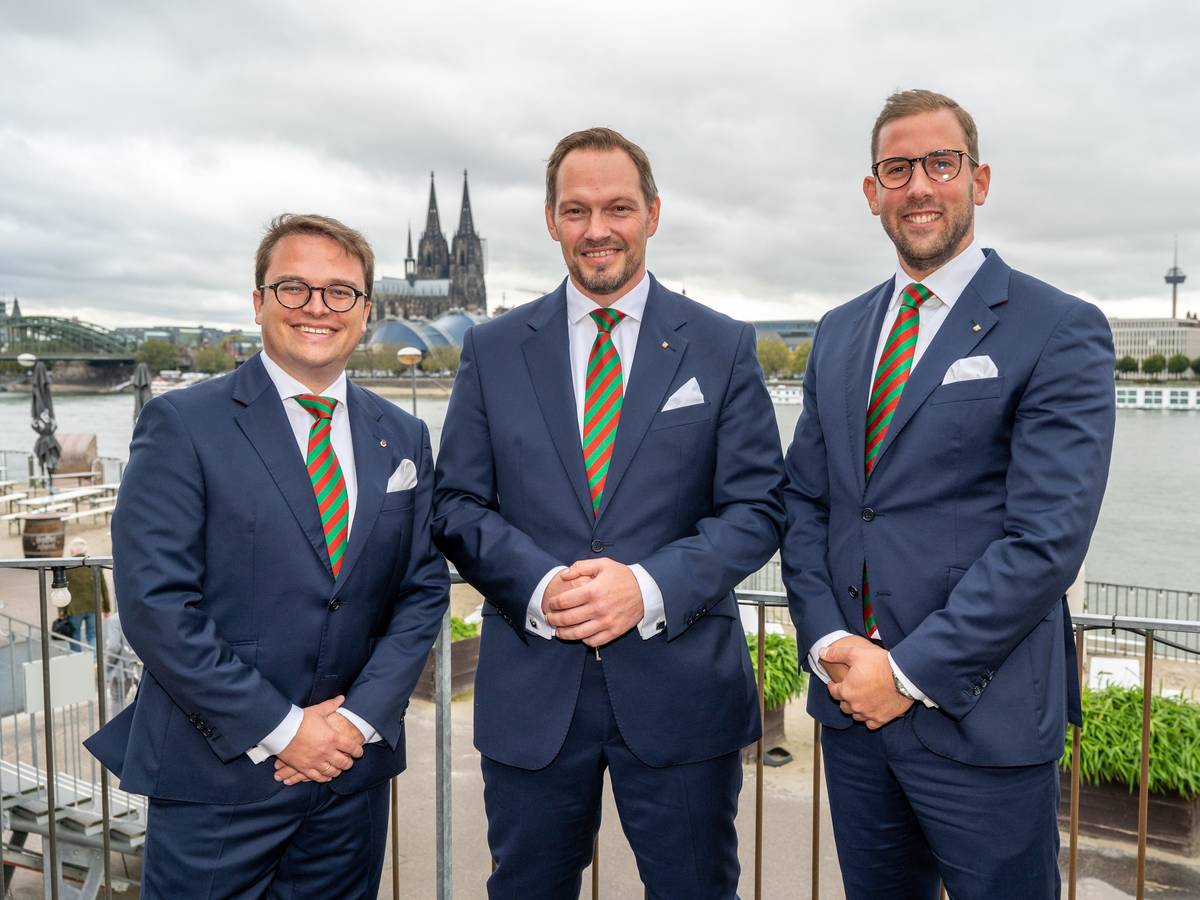 Das designierte Dreigestirn posiert gemeinsam vor Rheinkulisse in Deutz.