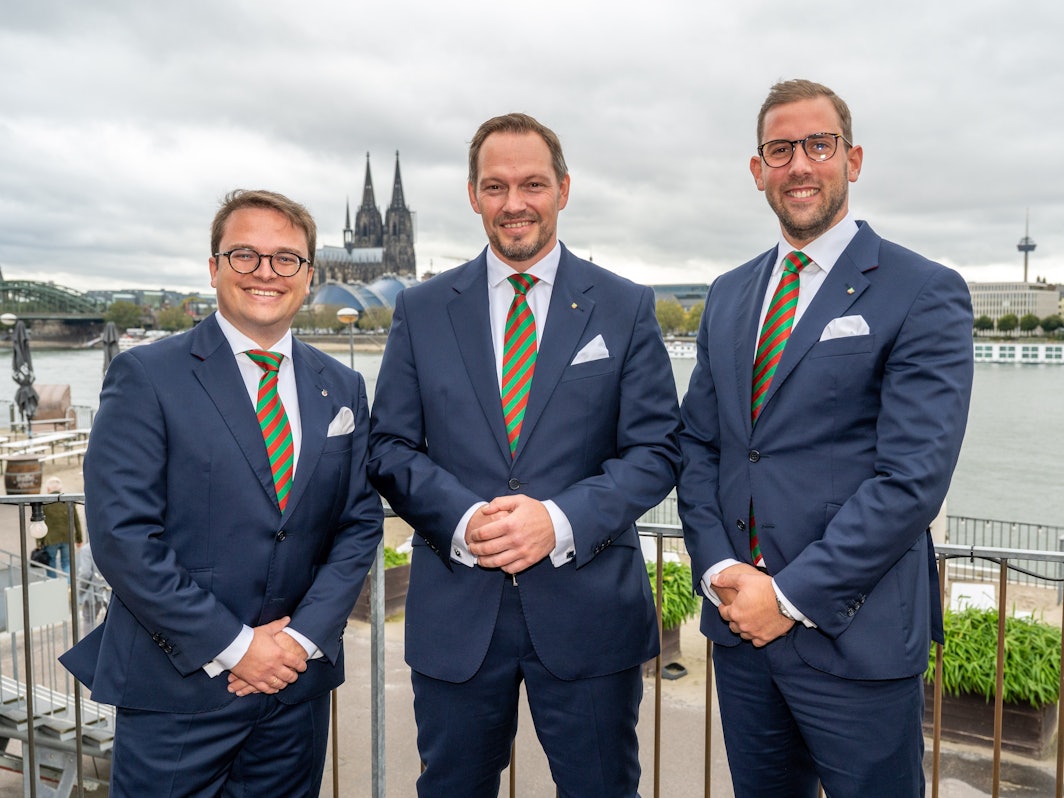 Das designierte Dreigestirn posiert gemeinsam vor Rheinkulisse in Deutz.