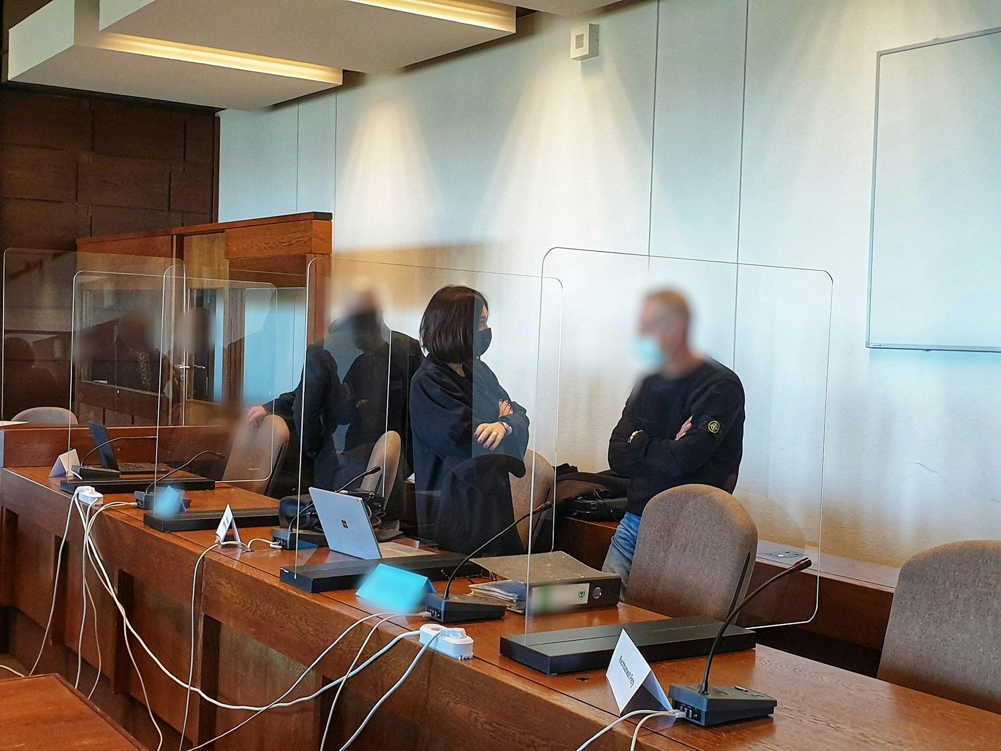 Köln: Rechtsanwältin spricht im Gerichtssaal mit ihrem Mandanten.