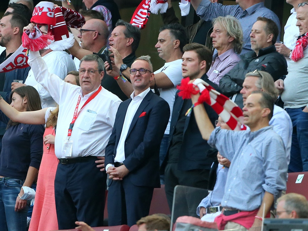 Werner Wolf und Alexander Wehrle stehen beim Bundesliga-Spiel 1. FC Köln gegen RB Leipzig auf der Tribüne.