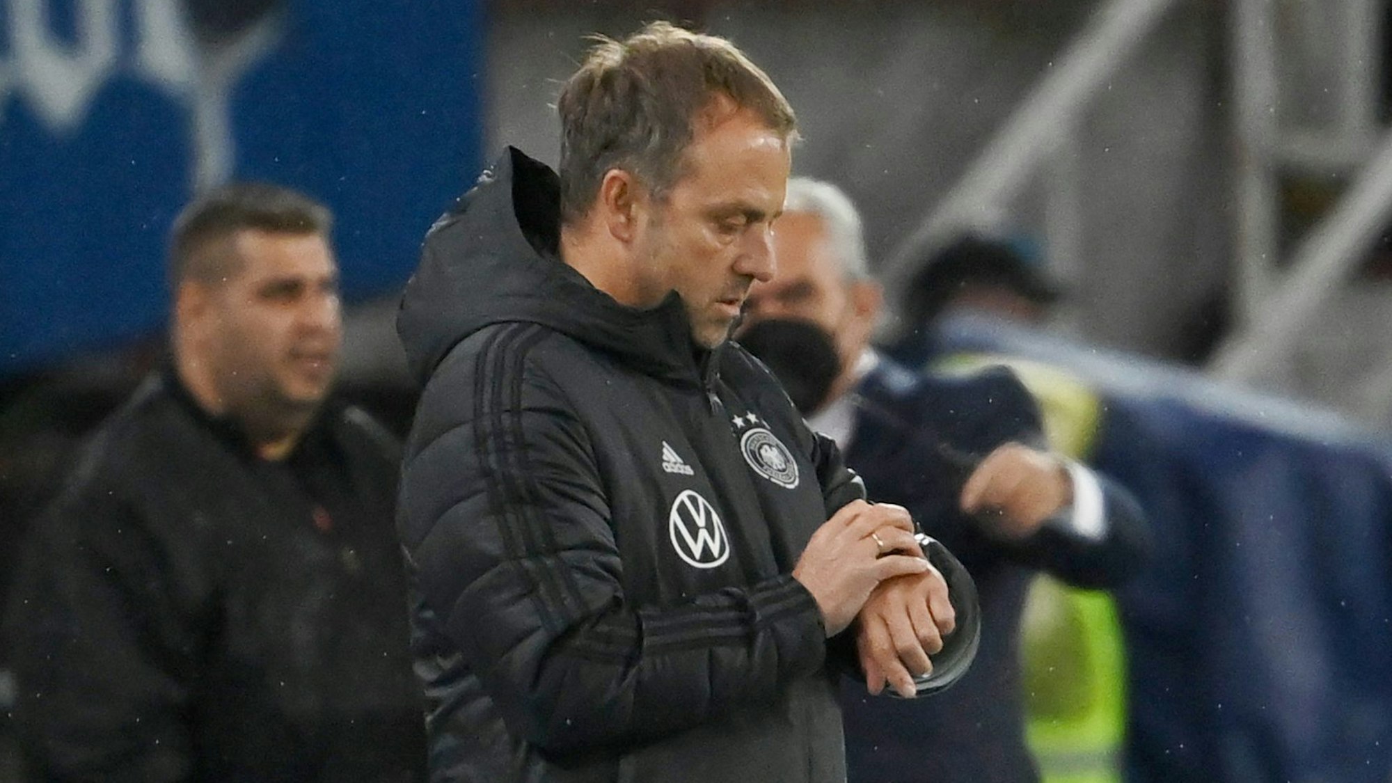 Hansi Flick guckt im Deutschland-Spiel in Nordmazedonien auf seine Uhr.