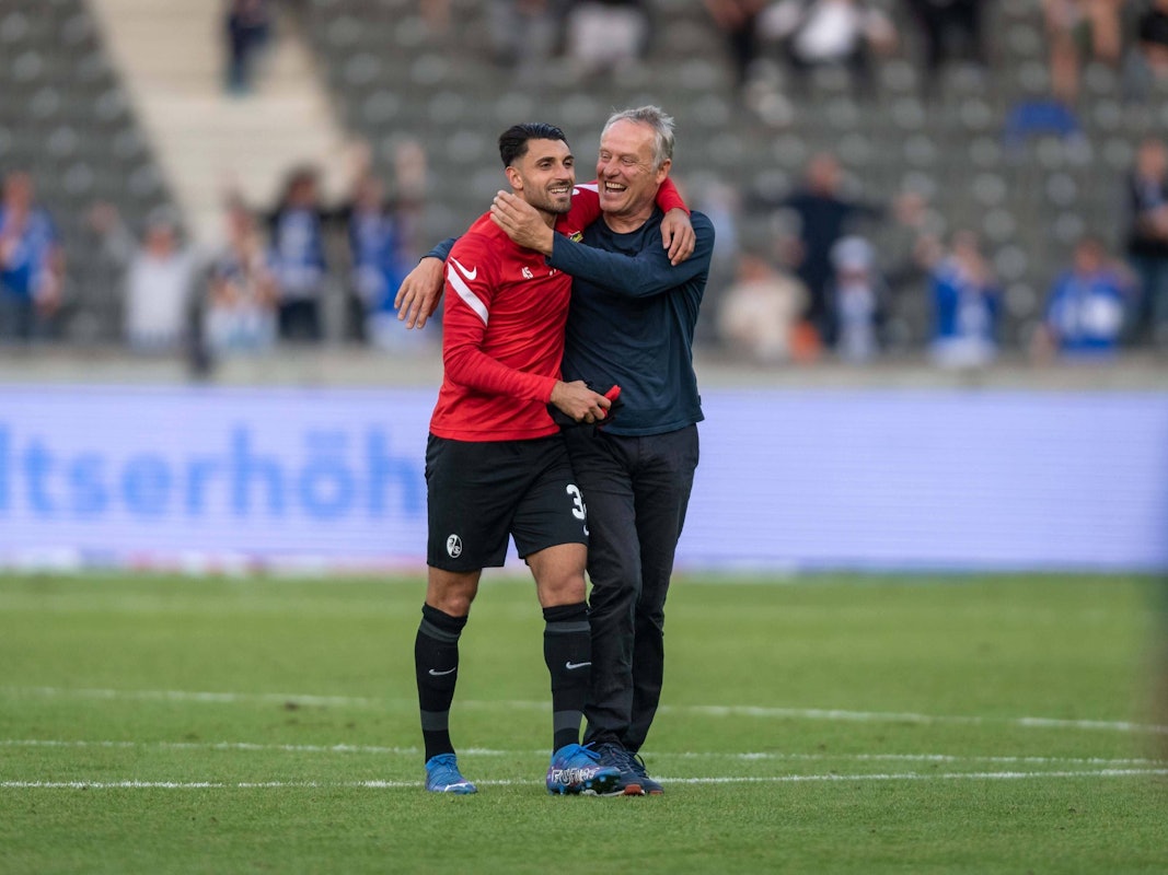Christian Streich (r.) und Vincenzo Grifo (l.) laufen Arm und Arm über den Platz.