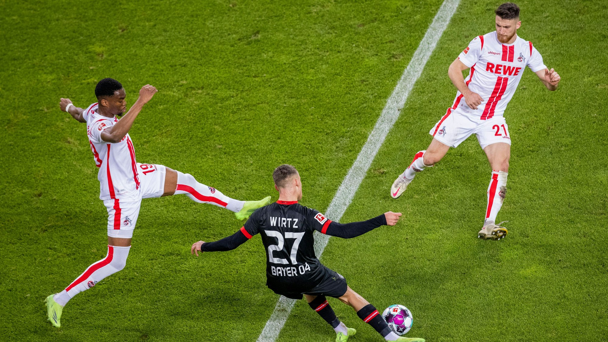 Florian Wirtz kommt gegen Kingsley Ehizibue und Salih Özcan zum Abschluss.