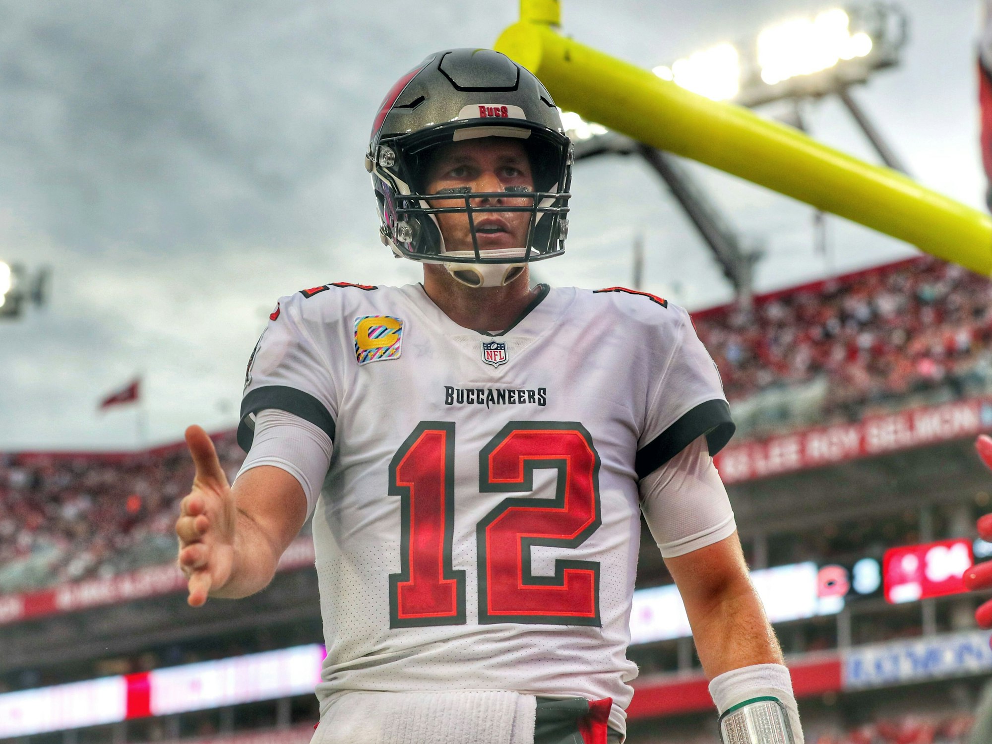 Tom Brady streckt seine rechte Hand aus, um seinem Mitspieler Mike Evans zu gratulieren.