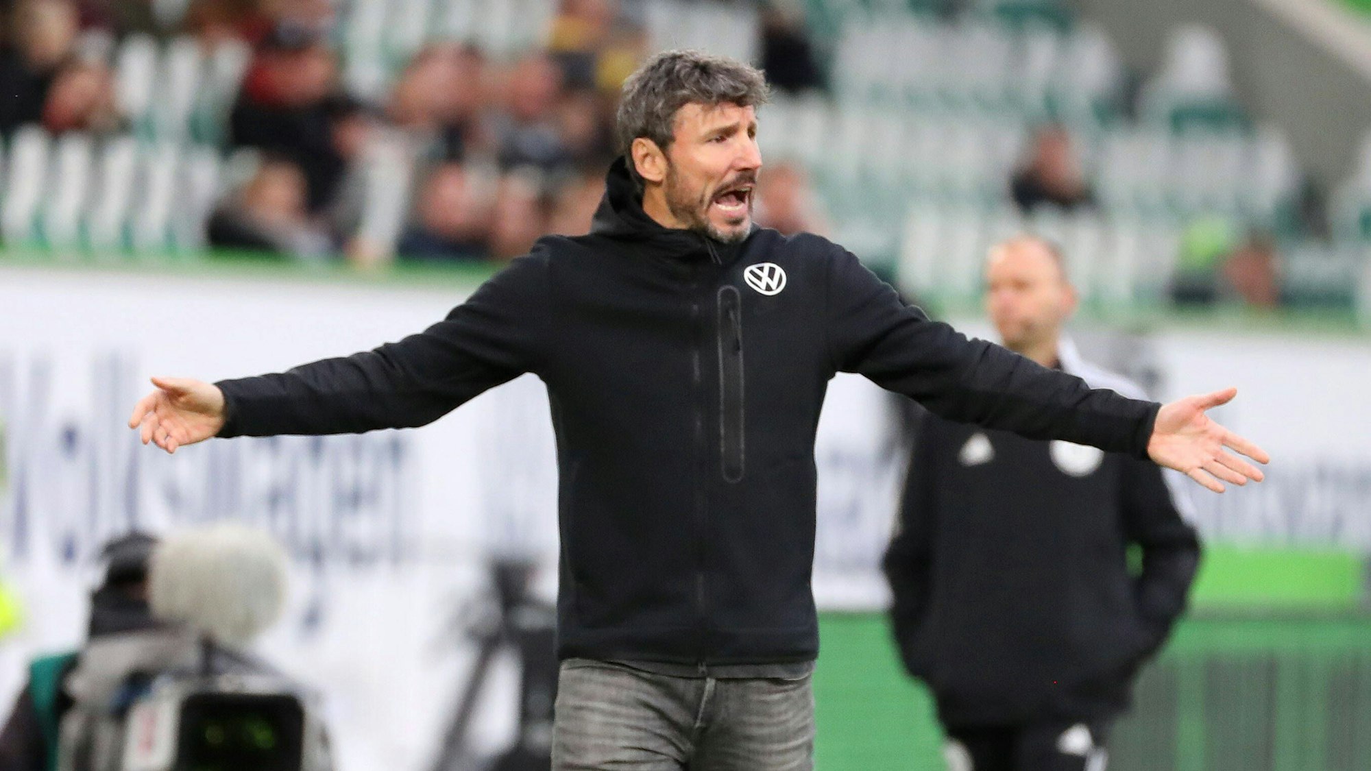 Mark van Bommel breitet verständnislos die Arme aus.