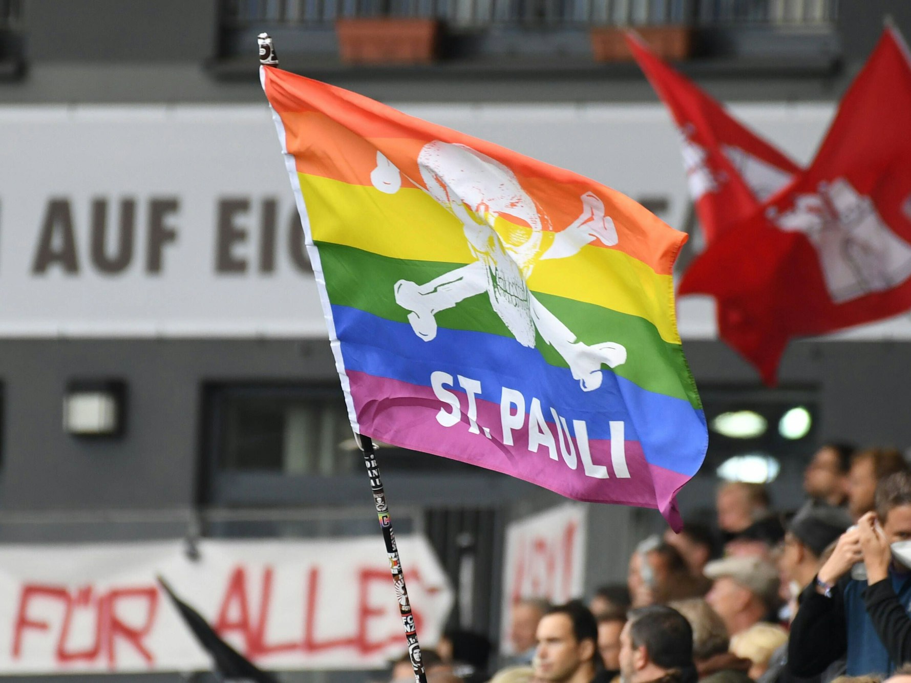 Eine Regenbogenfahne mit Totenkopf weht am Millerntor.