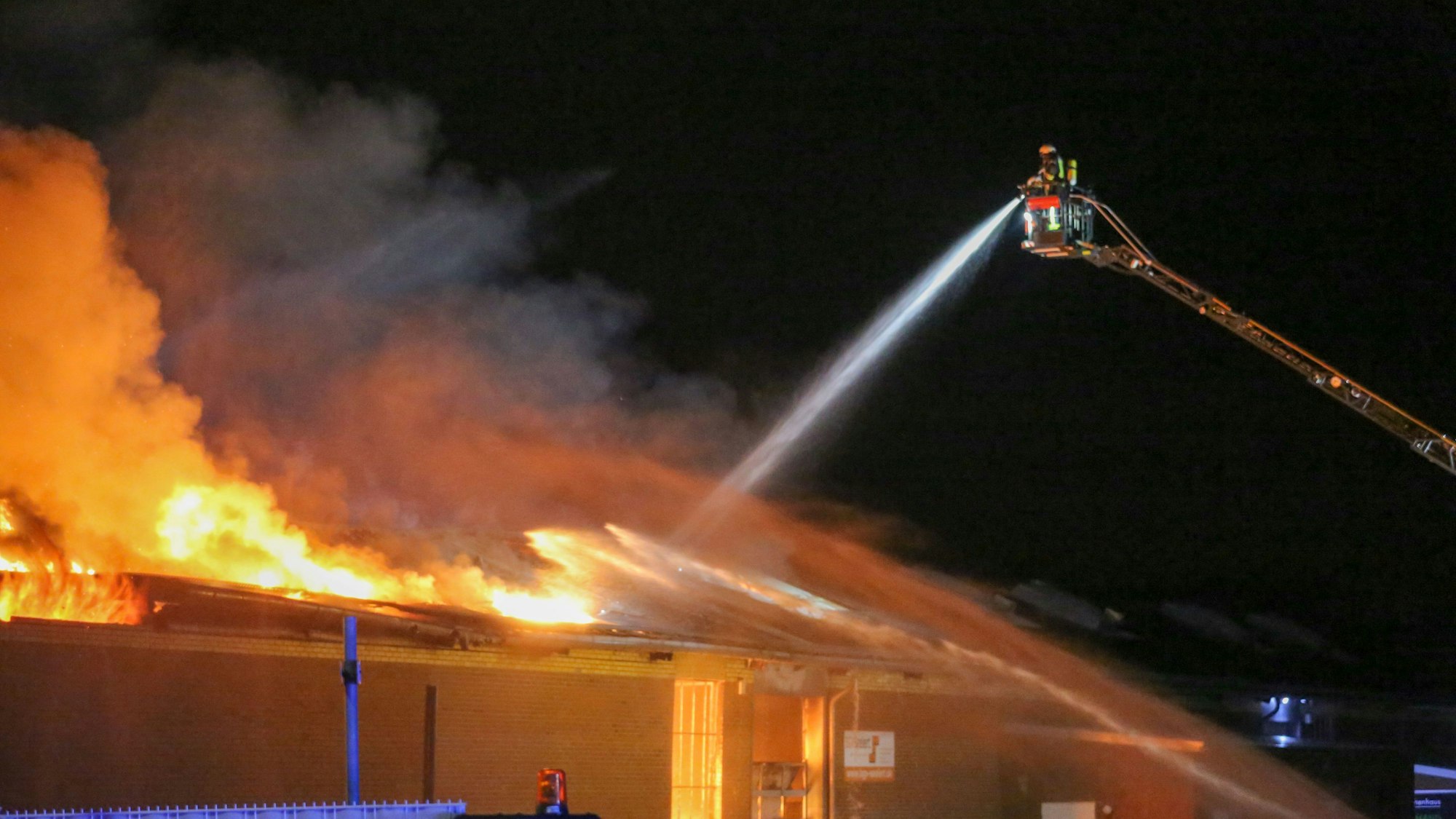 Die Feuerwehr versucht, einen Großbrand in einem Gewerbekomplex zu löschen.