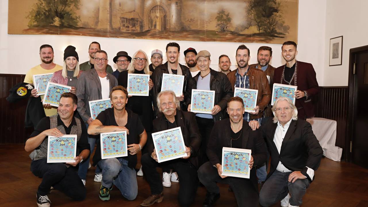Zahlreiche Künstler halten das Cover des neuen Samplers in den Händen.