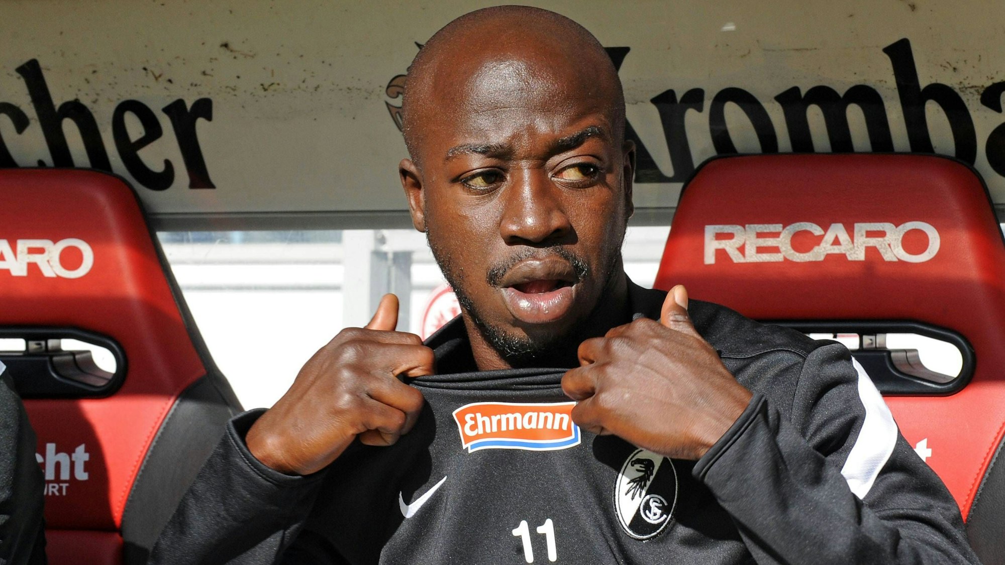 Der Freiburger Spieler Garra Dembélé sitzt auf der Auswechselbank.