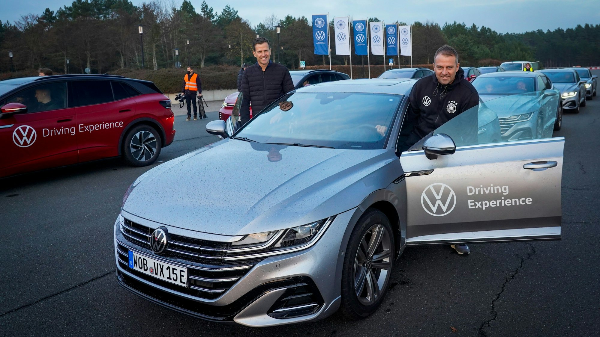 Hansi Flick steigt in ein E-Auto ein.