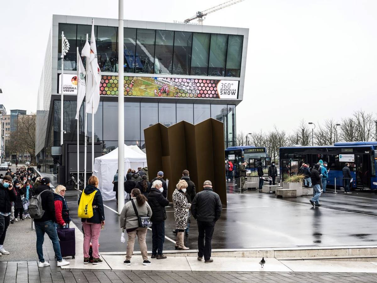 Dortmund: Eine lange Schlange hat sich vor einem mobilen Impfzentrum mit zwei Impfbussen vor dem Deutschen Fußballmuseum gebildet.